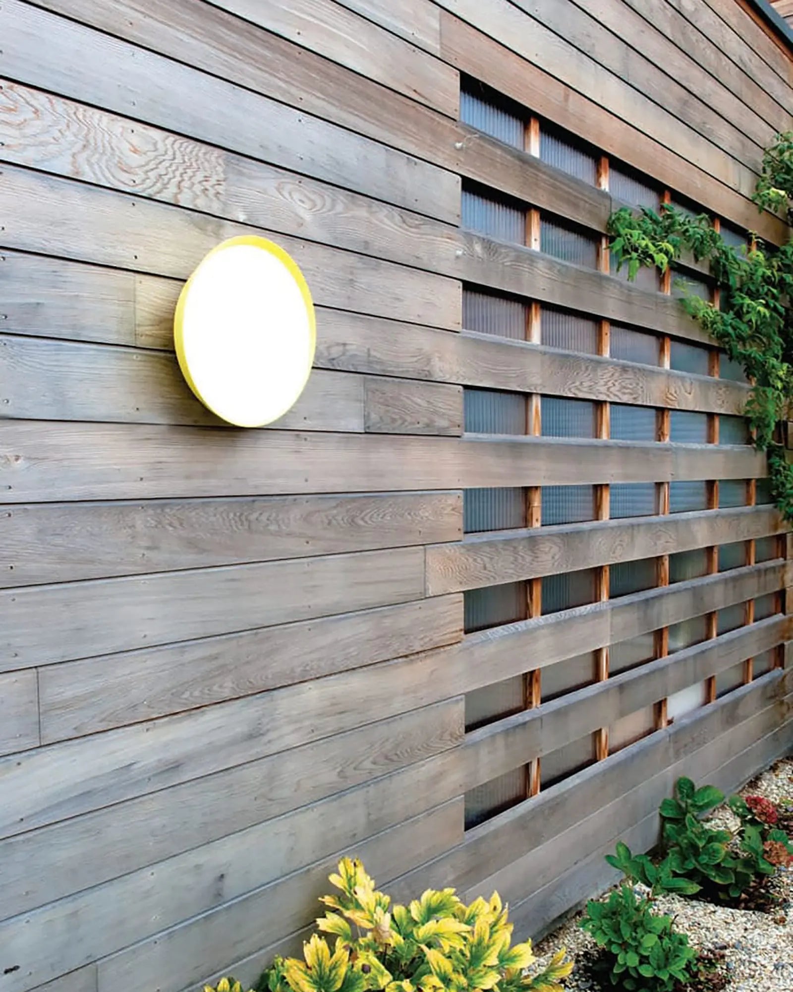 Mona Outdoor circular wall light on timber wall