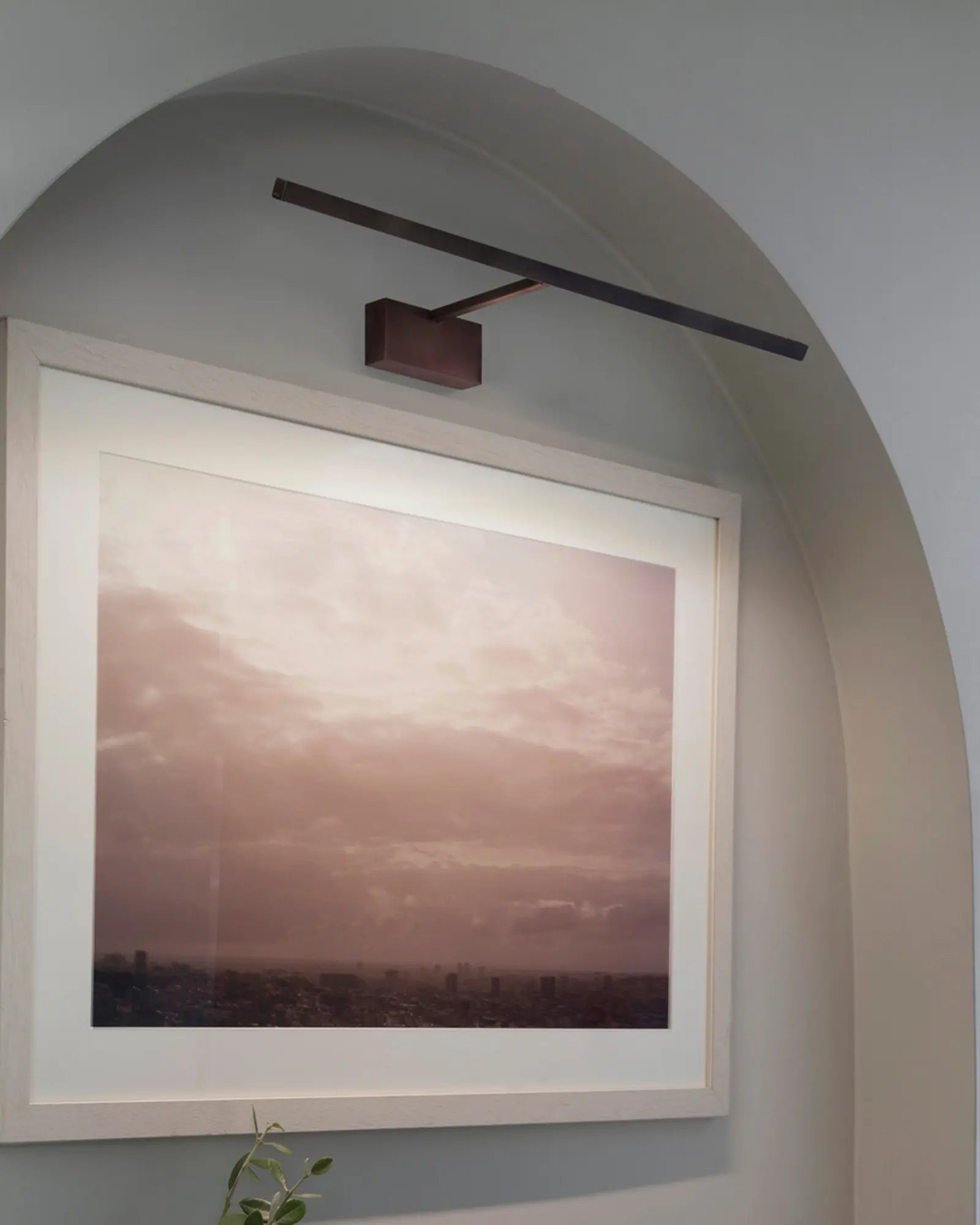 Mondrian linear frame wall light above a picture