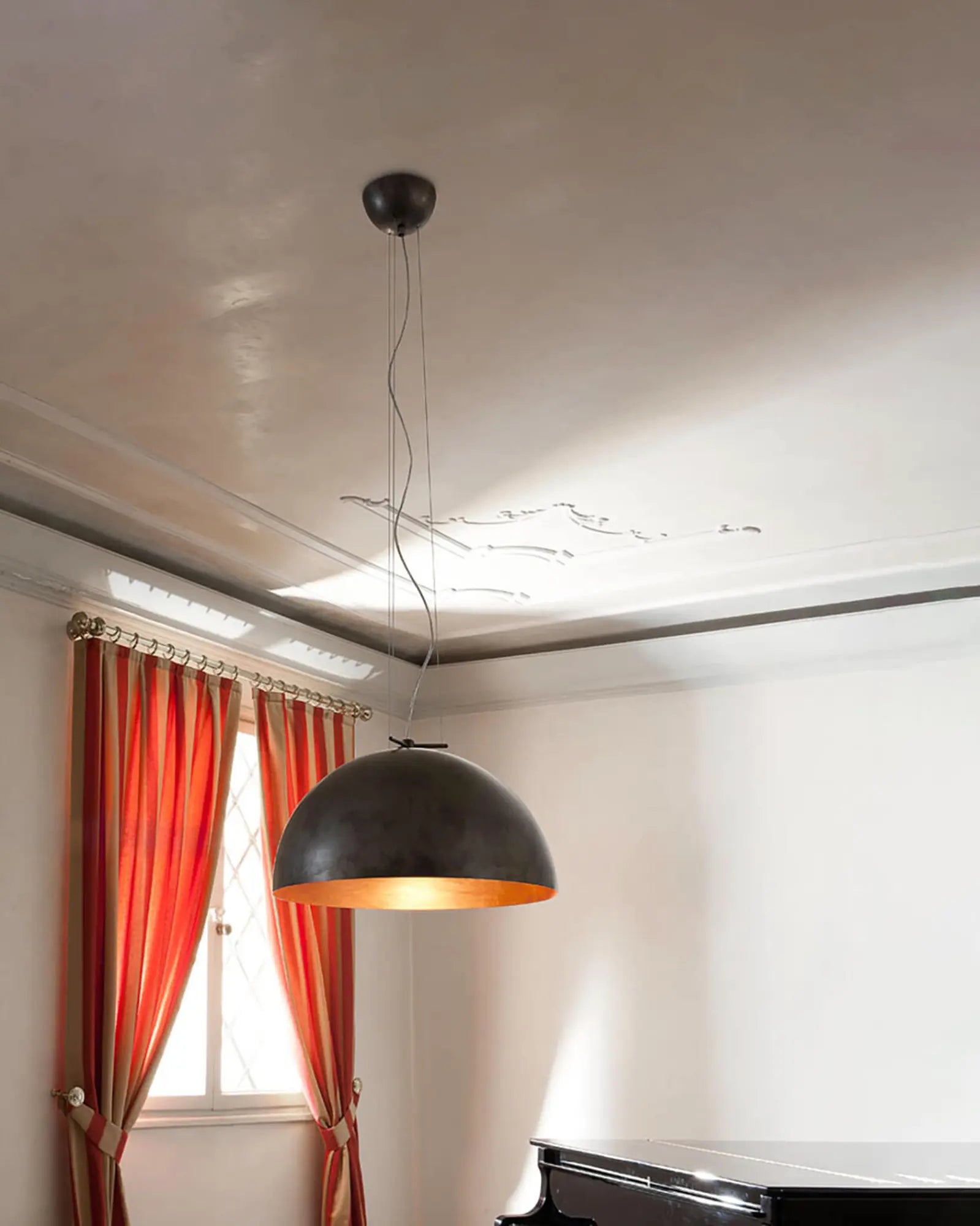 Moonlight pendant light above a piano