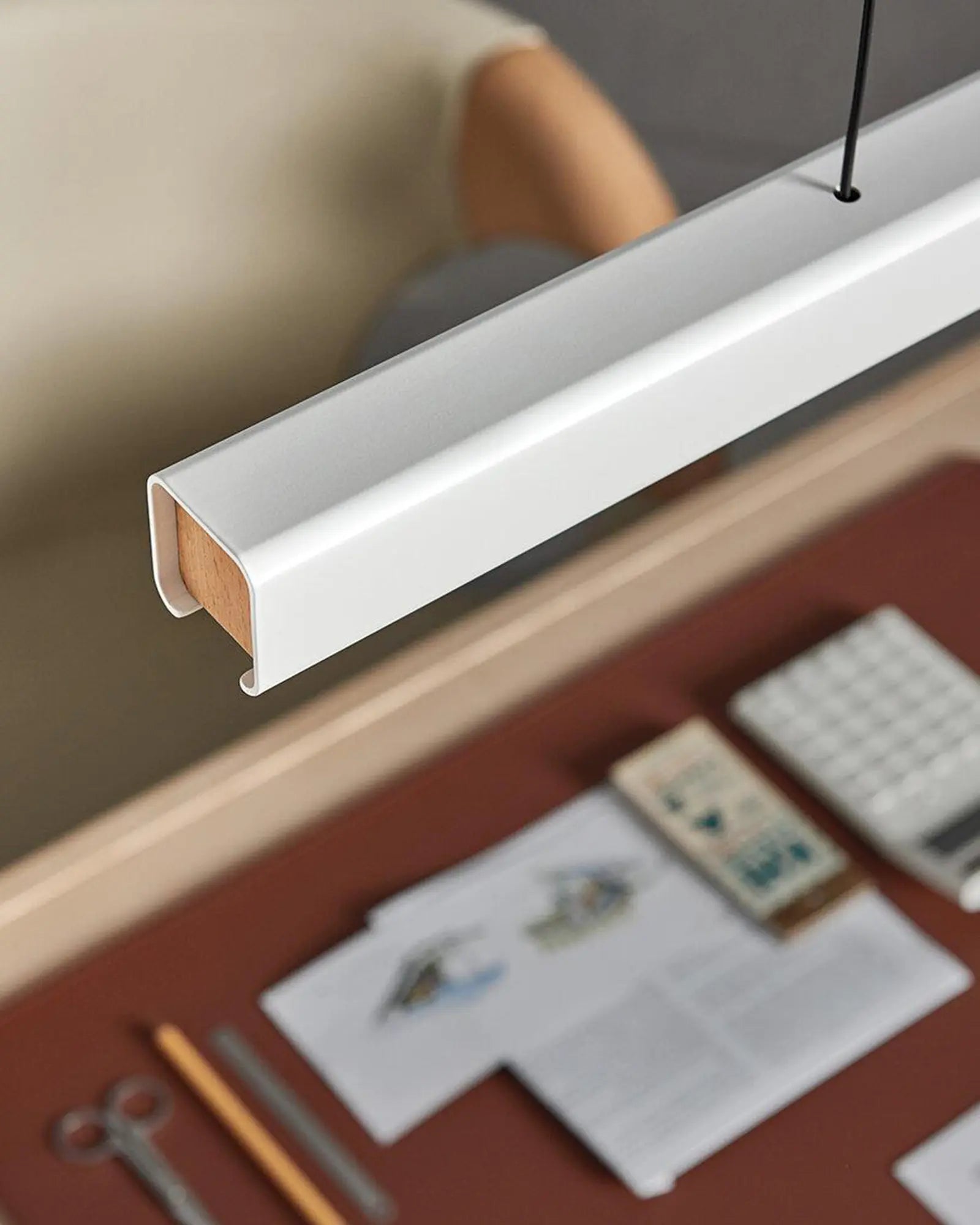 Mumu modern linear pendant light above a desk