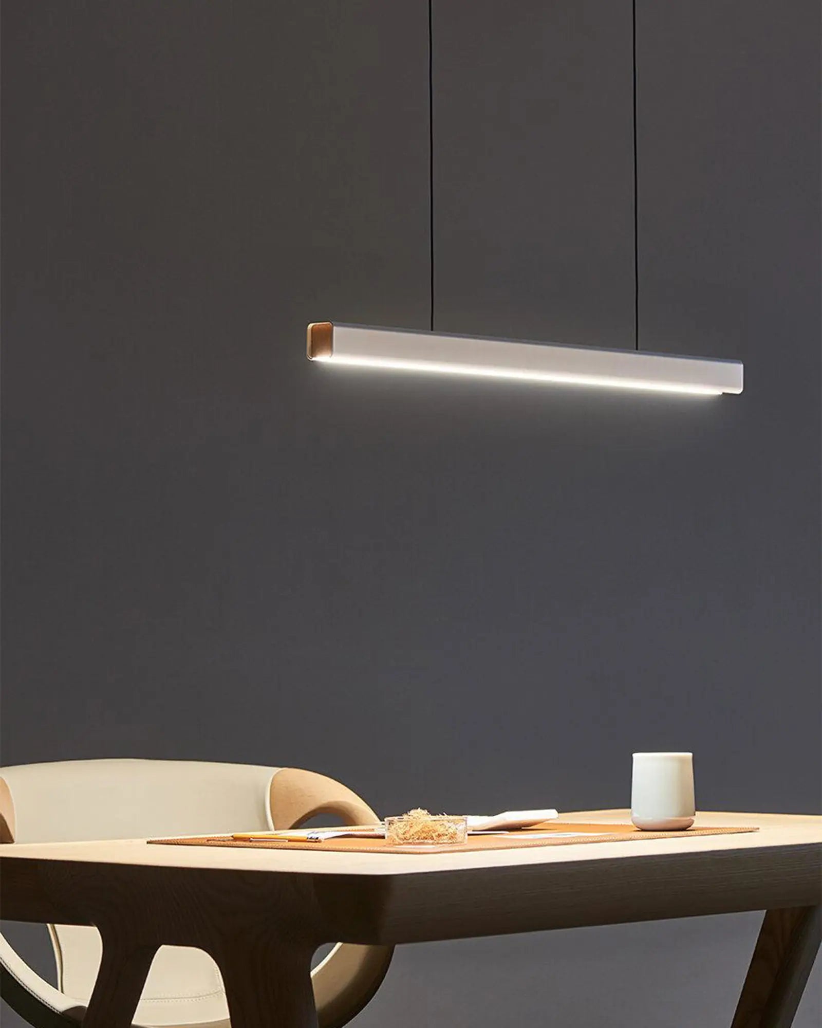 Mumu modern linear pendant light above a desk