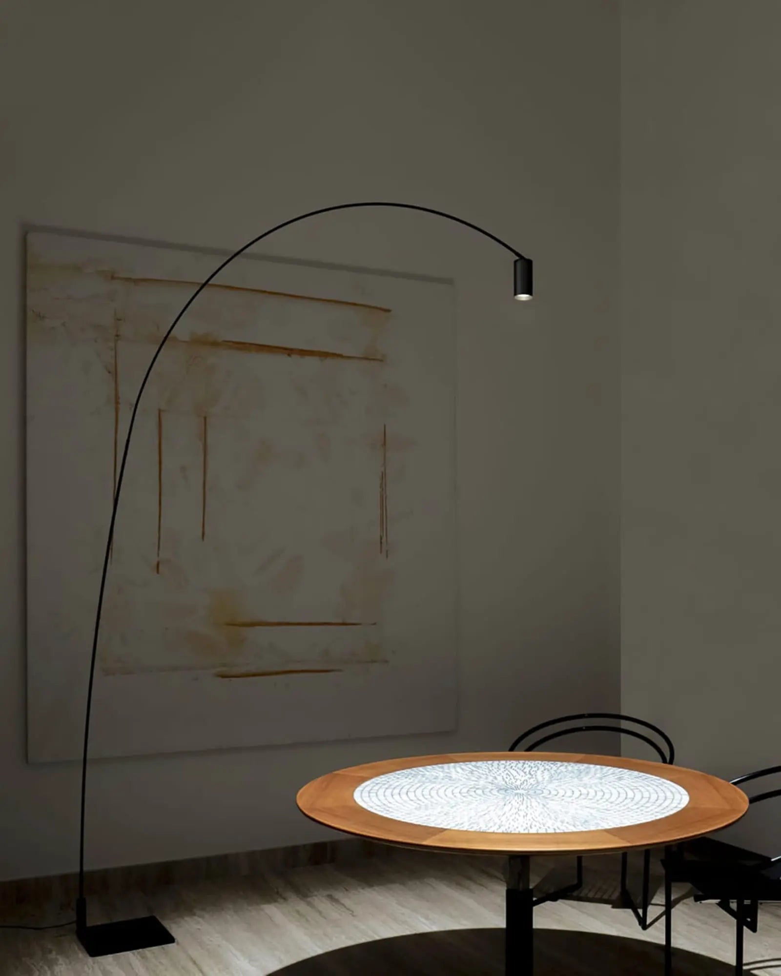 Fox contemporary tall floor lamp with adjustable spotlight head  above a round table