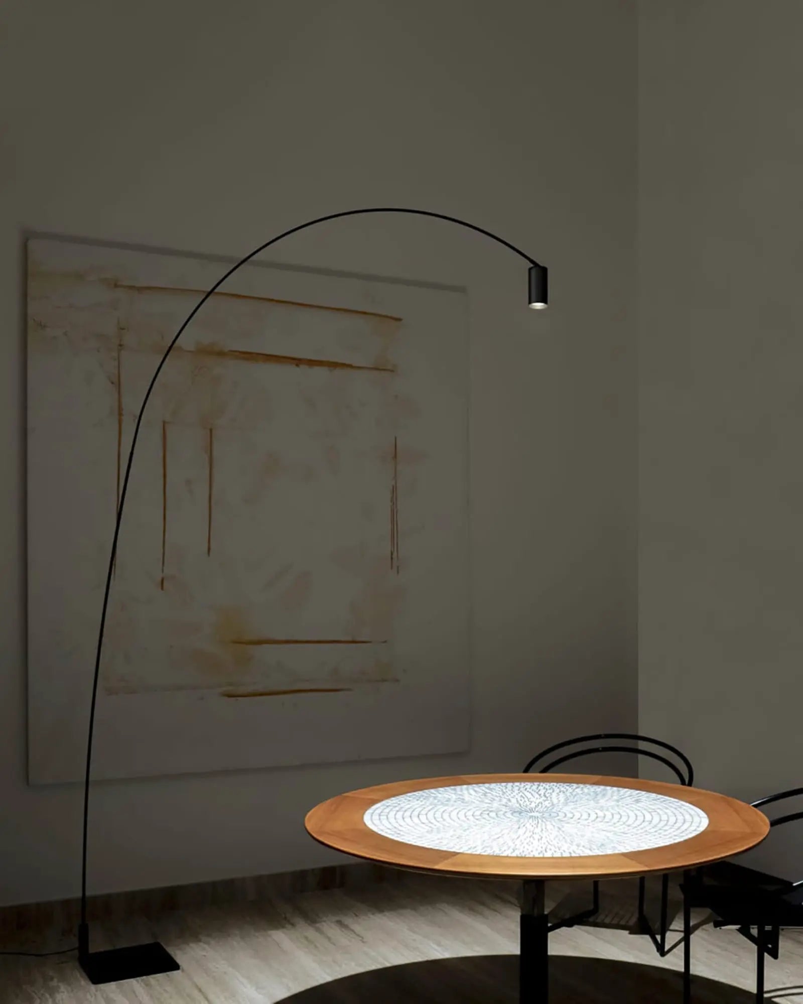 Fox contemporary tall floor lamp with adjustable spotlight head above a round table