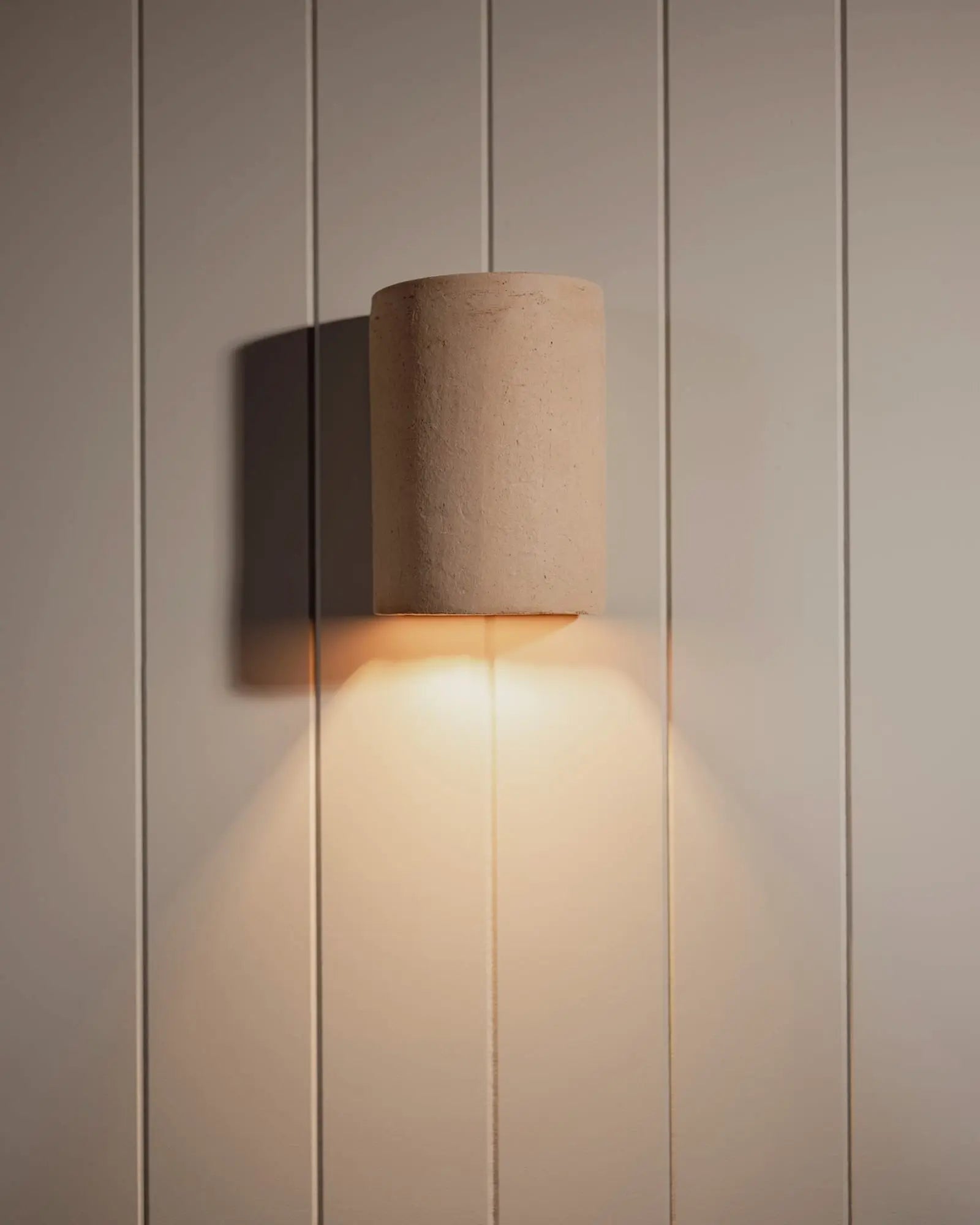 Nudie handmade ceramic outdoor wall light on cladded wall