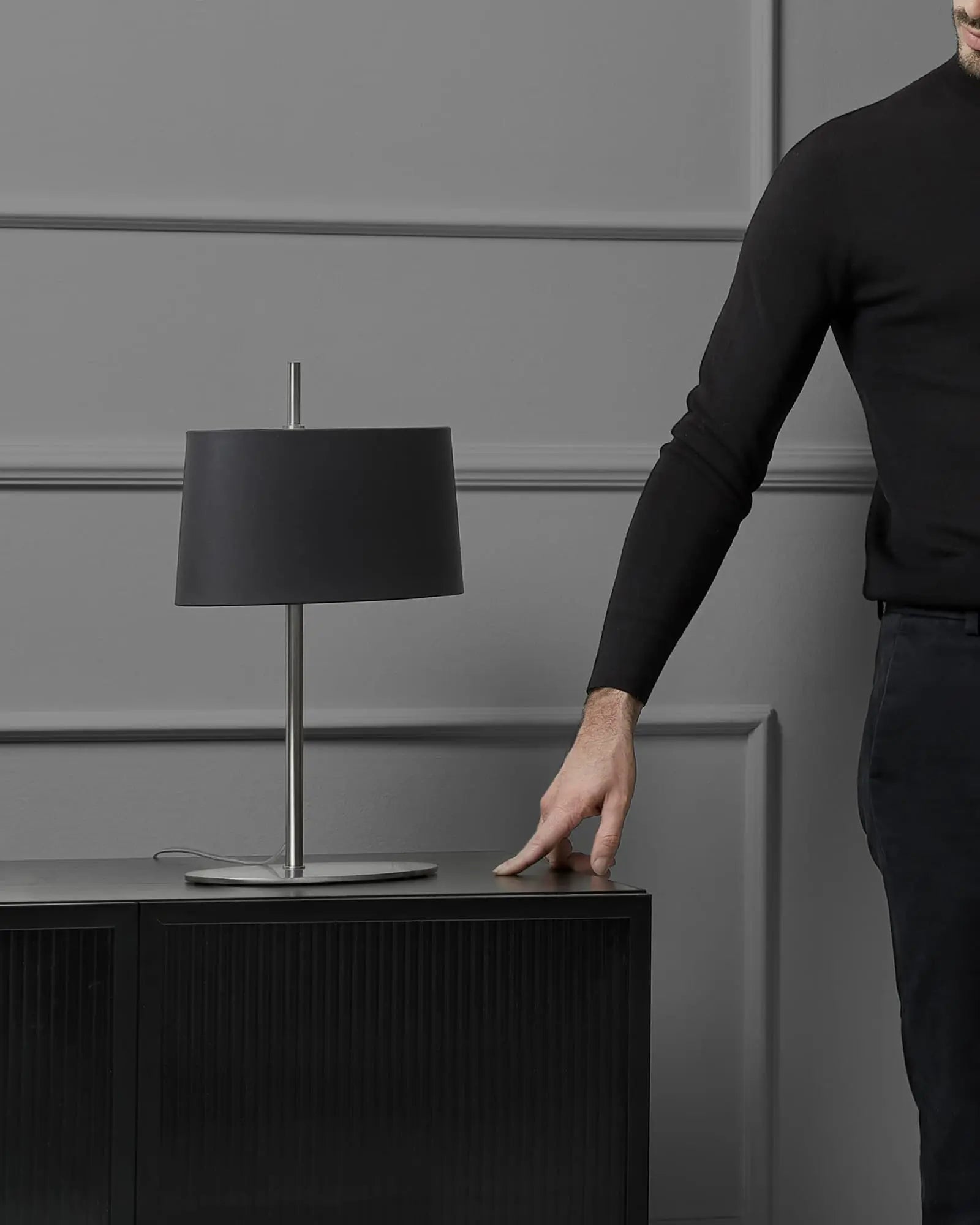Ona contemporary table lamp with fabric shade and metal body on a unit