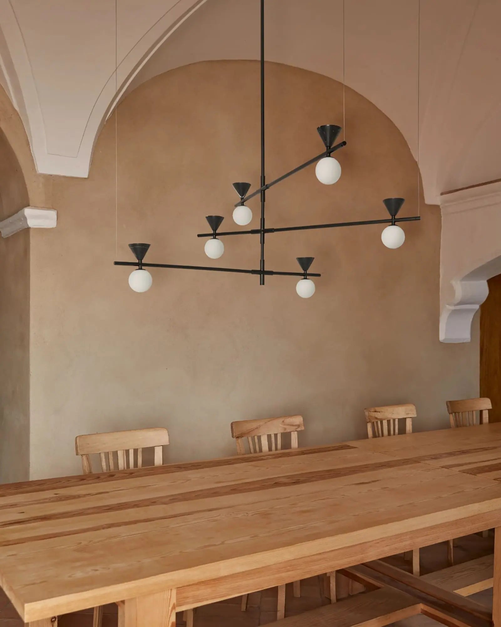 Oneta contemporary adjustable pendant light with 6 opal glass orb shades above a dining table