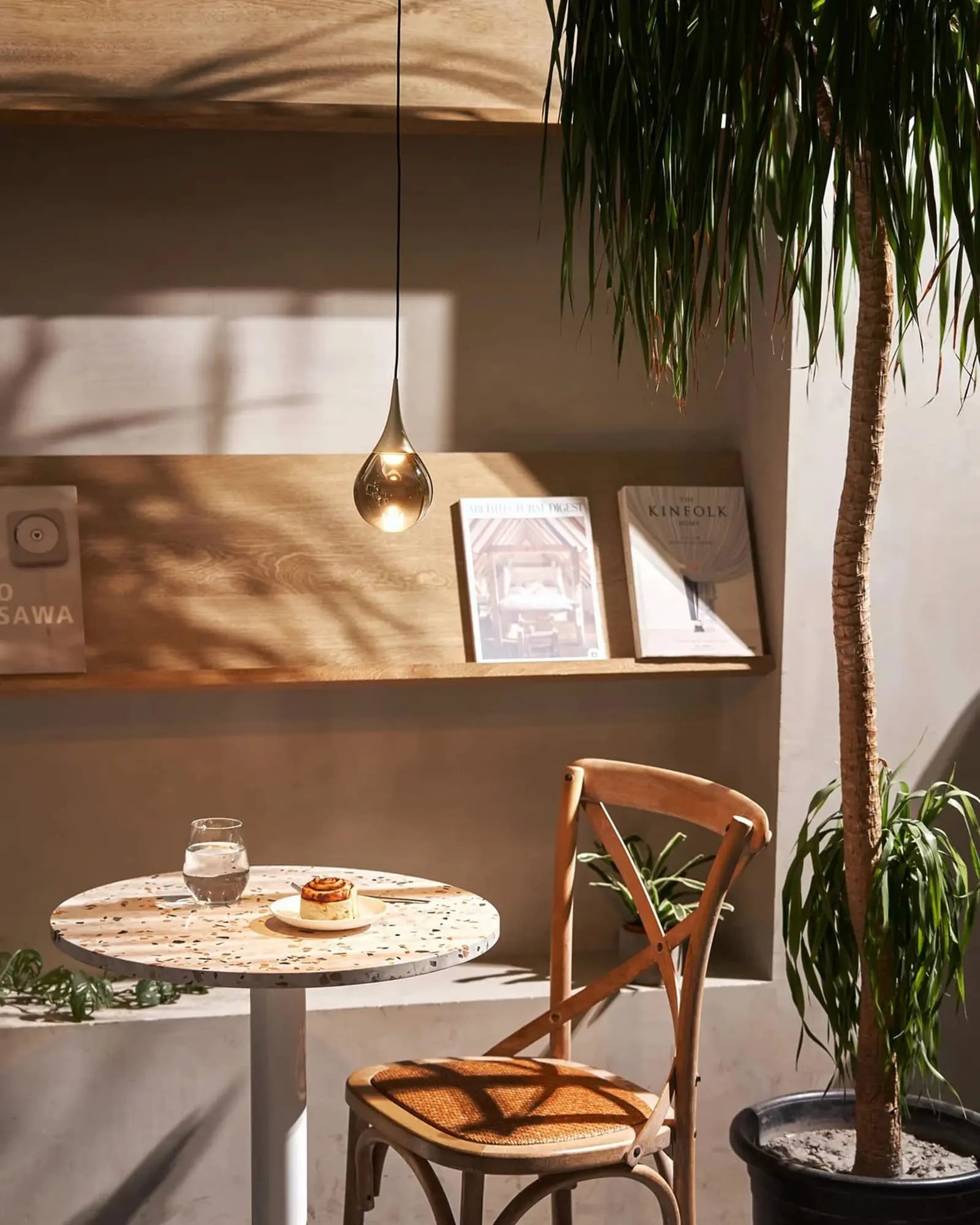 Pao Pao blown glass pendant light above a round table