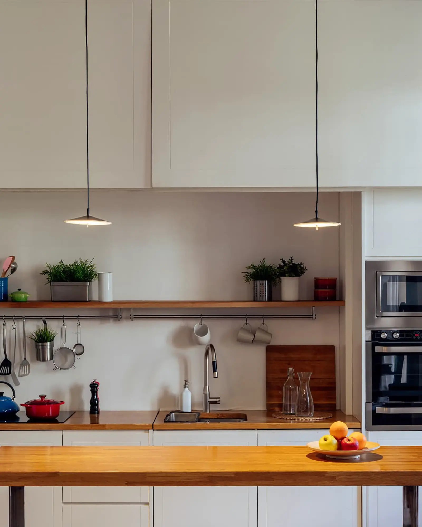 Pla modern flat dome pendant light cluster above dining area