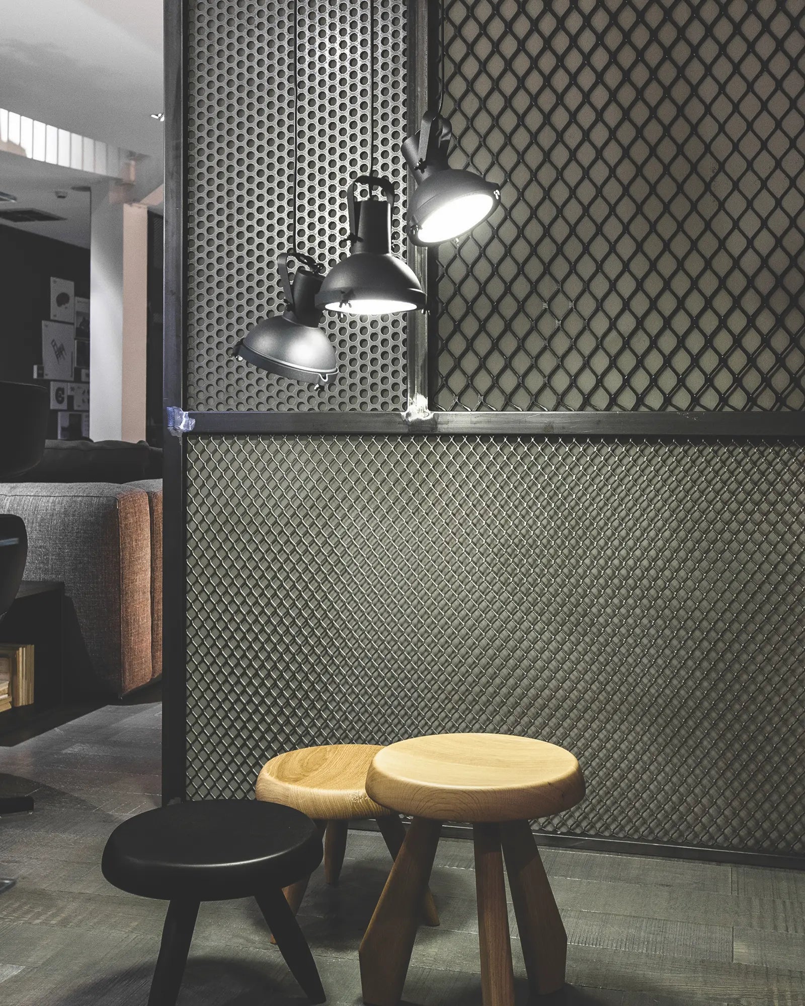 Projecteur classic iconic pendant light cluster above stools in a lounge area