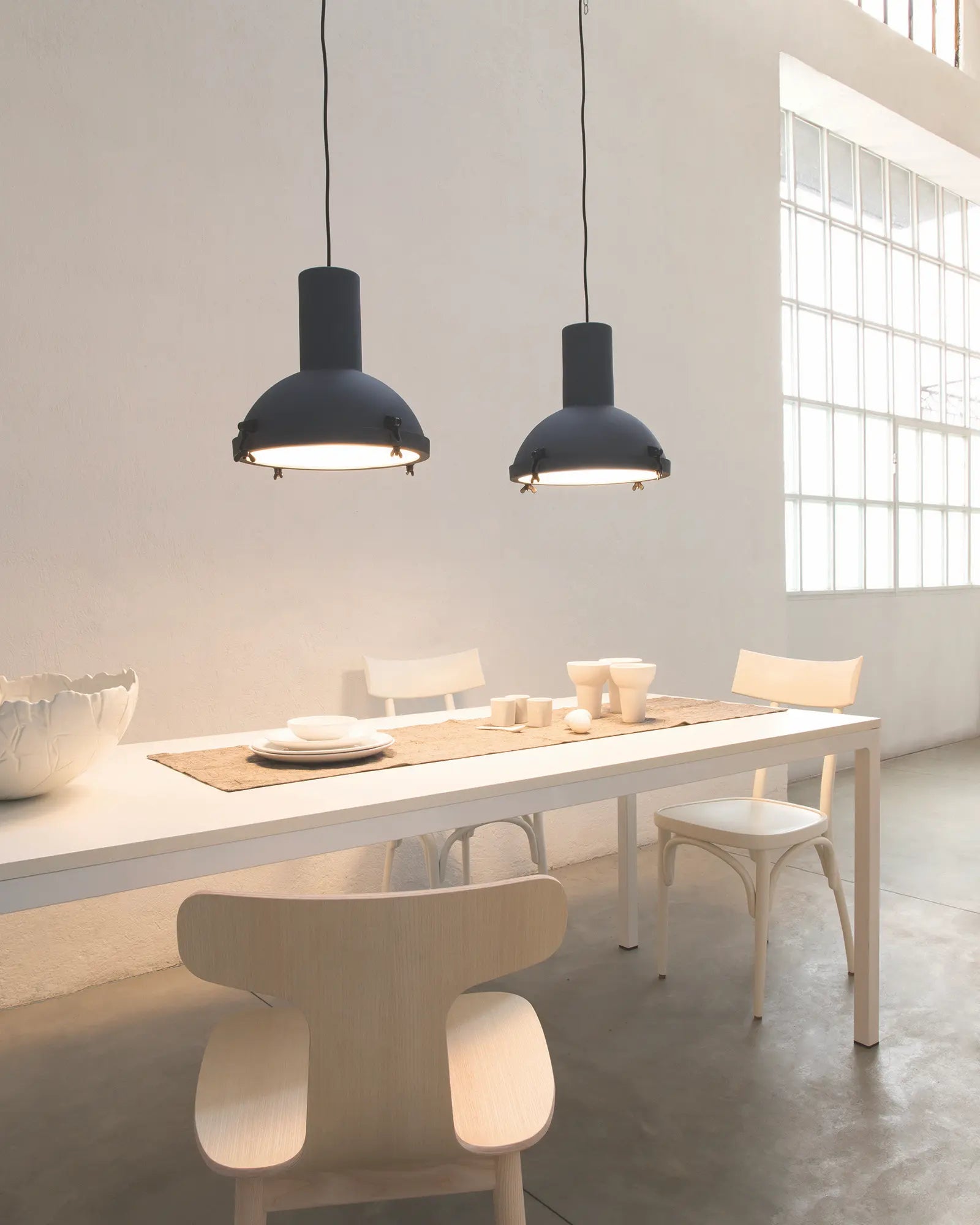 Projecteur classic iconic pendant light cluster over a dining table