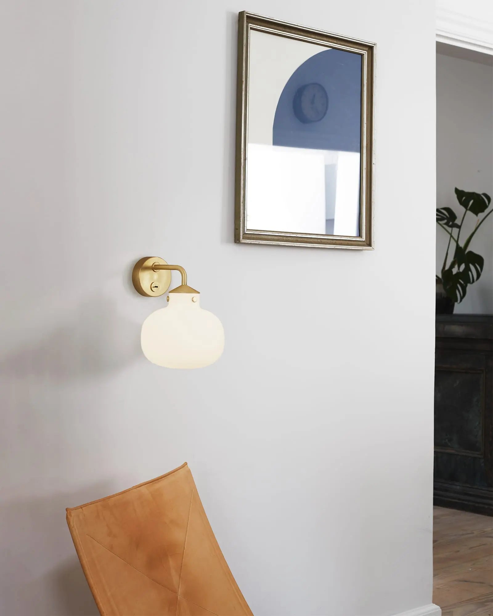 Raito wall light in a hallway above a seat
