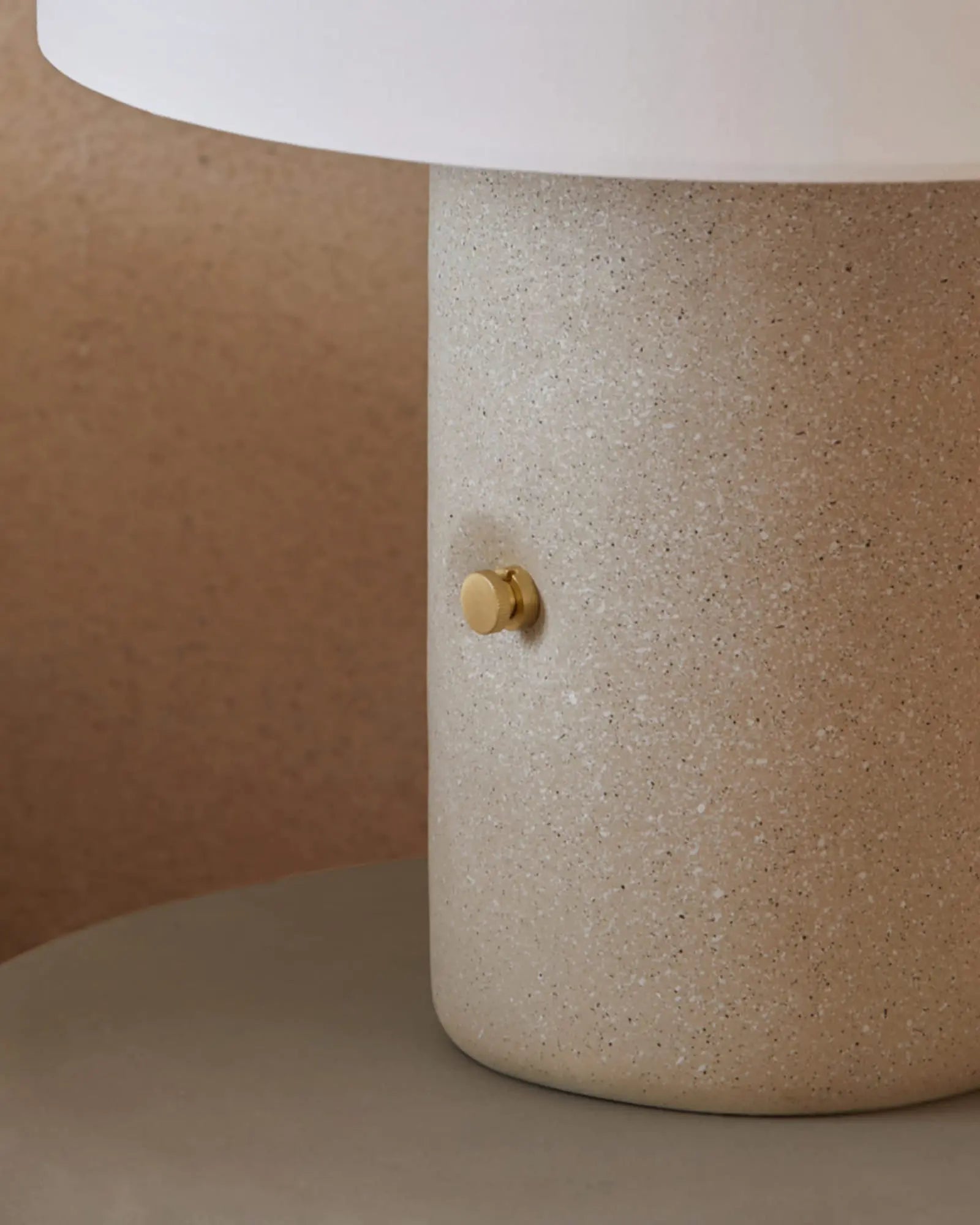Sand Terrazzo and fabric shade portable table lamp with brass details 