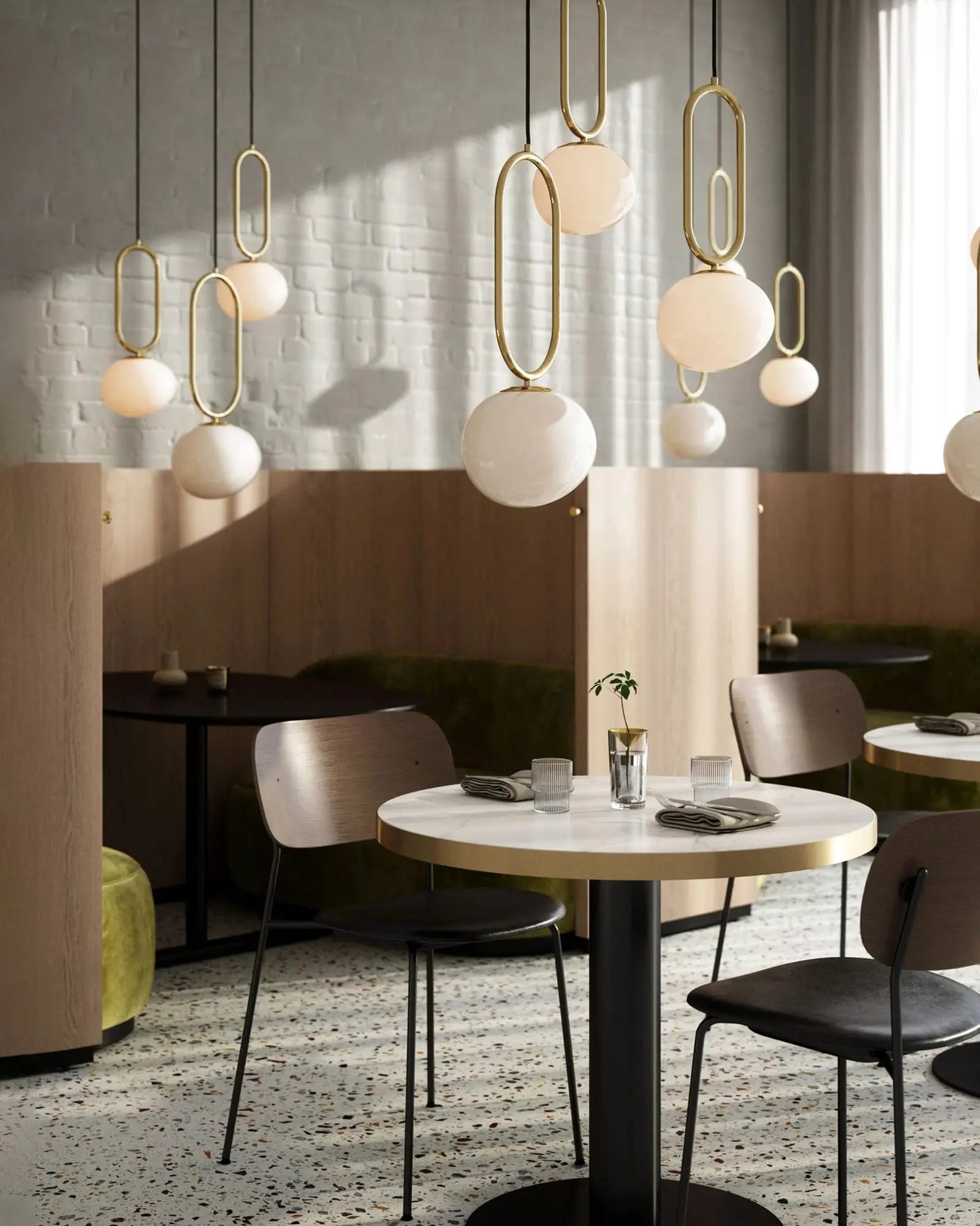 Shape brass and opal glass pendant light cluster in a restaurant above tables