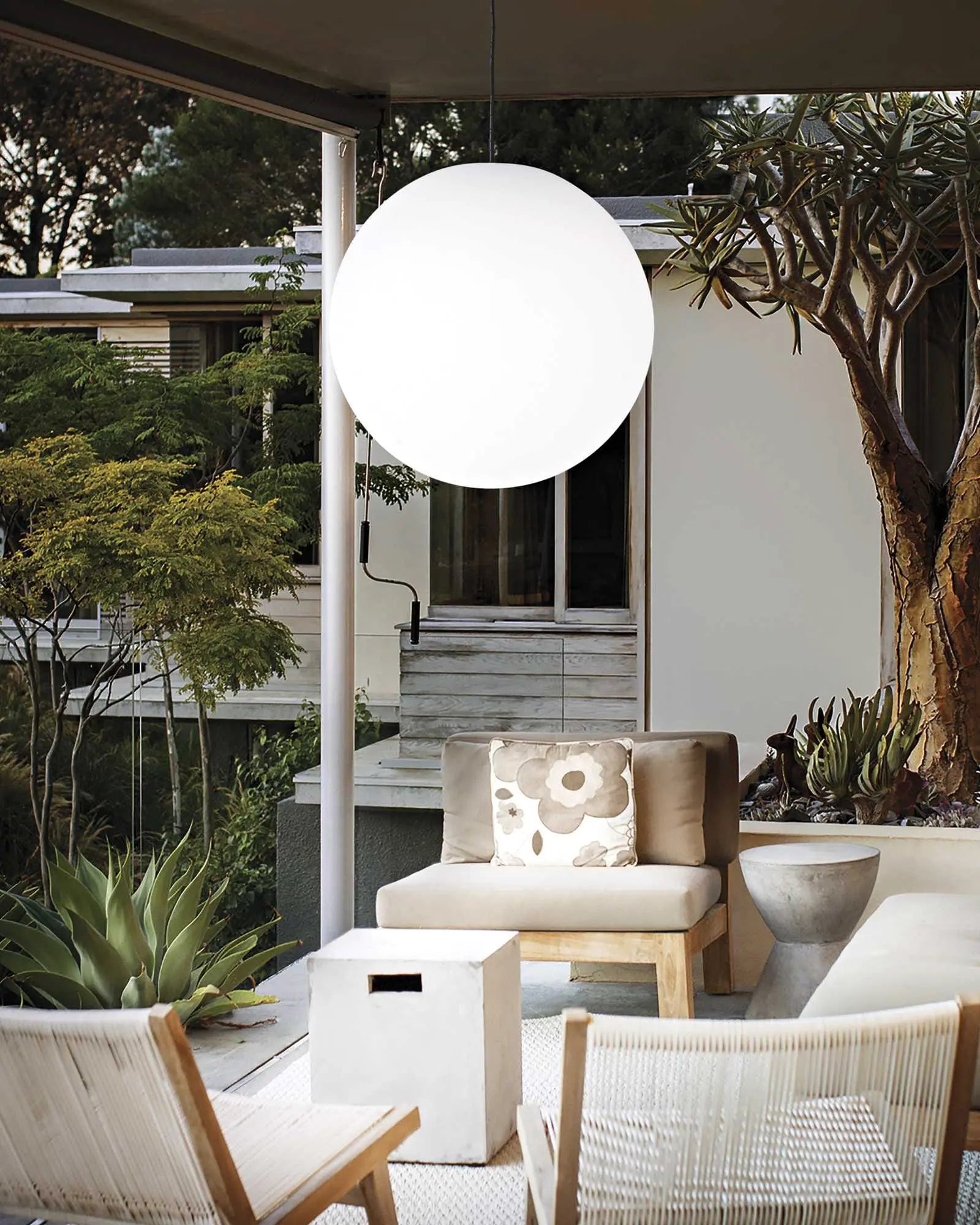 Sole orb outdoor pendant light above entertainment area