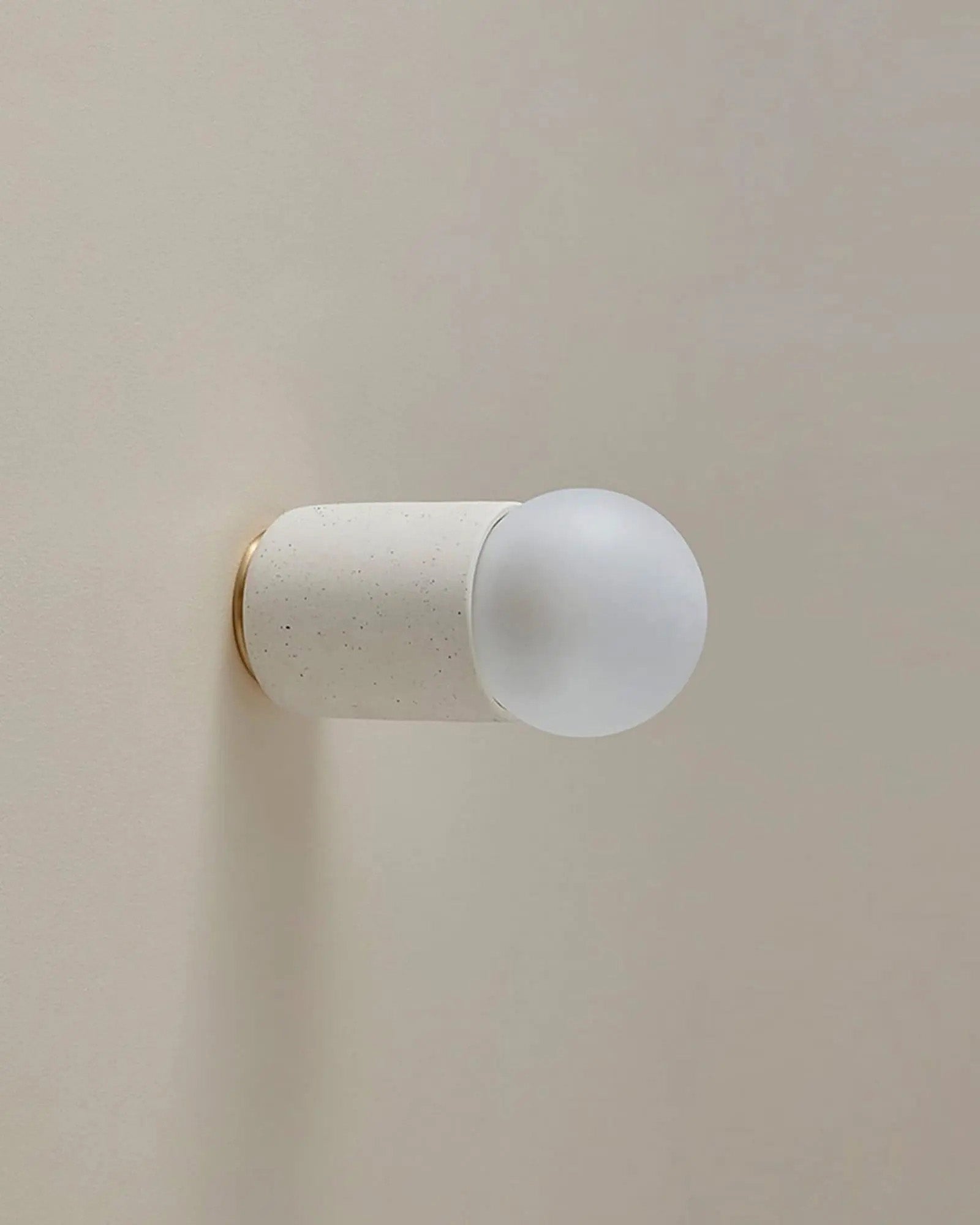 Terra 1 Wall Light in Vanilla Bean ceramic with brass finish. -Nook Collections