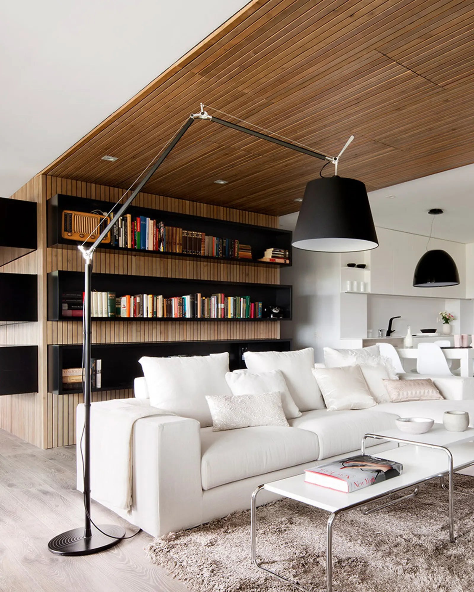 Tolomeo mega Italian iconic adjustable designer floor lamp above a sofa