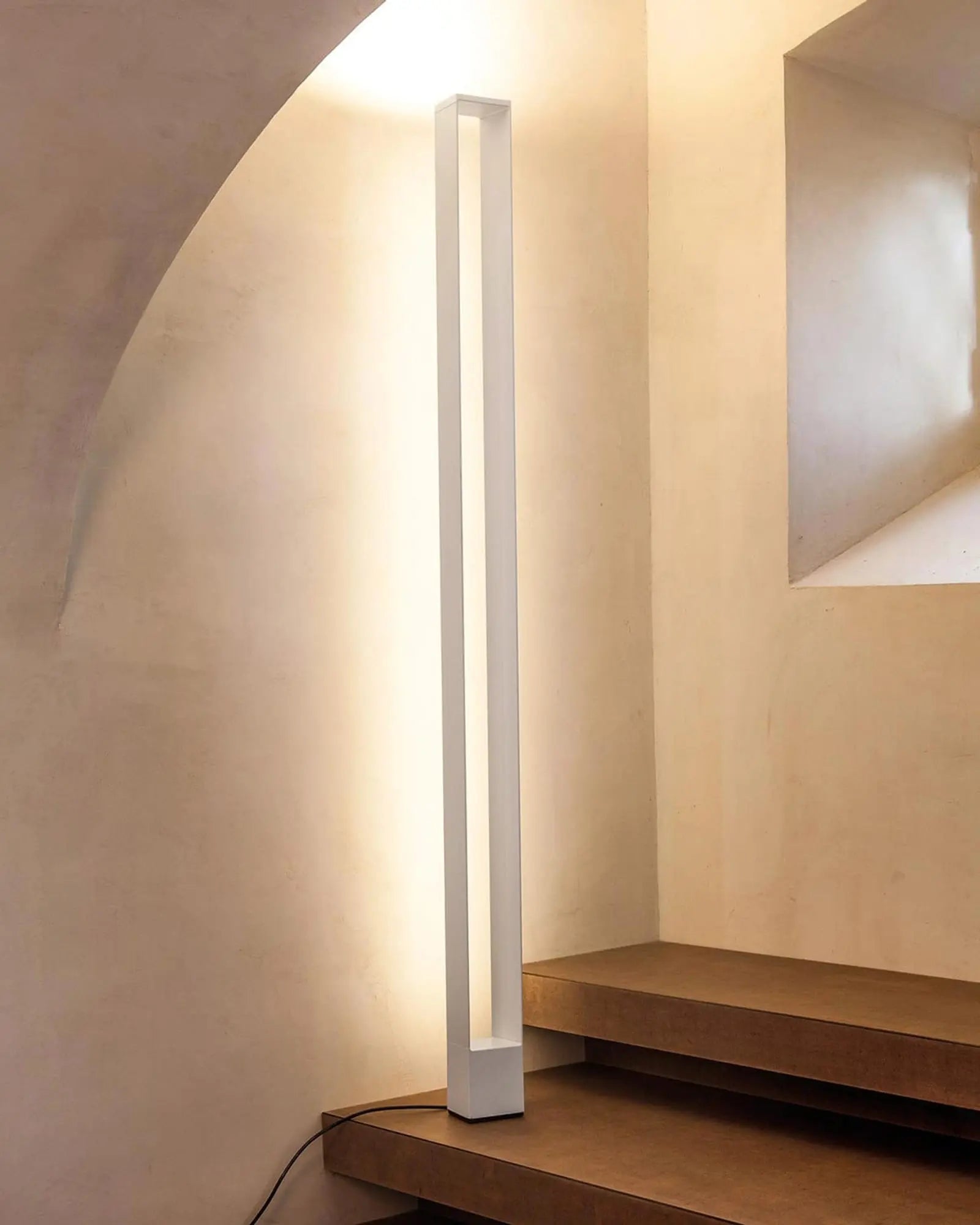 Tru modern minimal rectangular frame tall floor lamp on a staircase