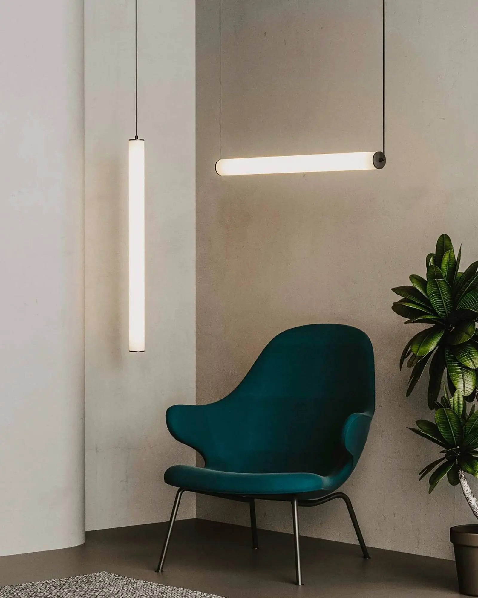 Tube linear opal shade pendant light vertical and horizontal cluster above a chair in living area