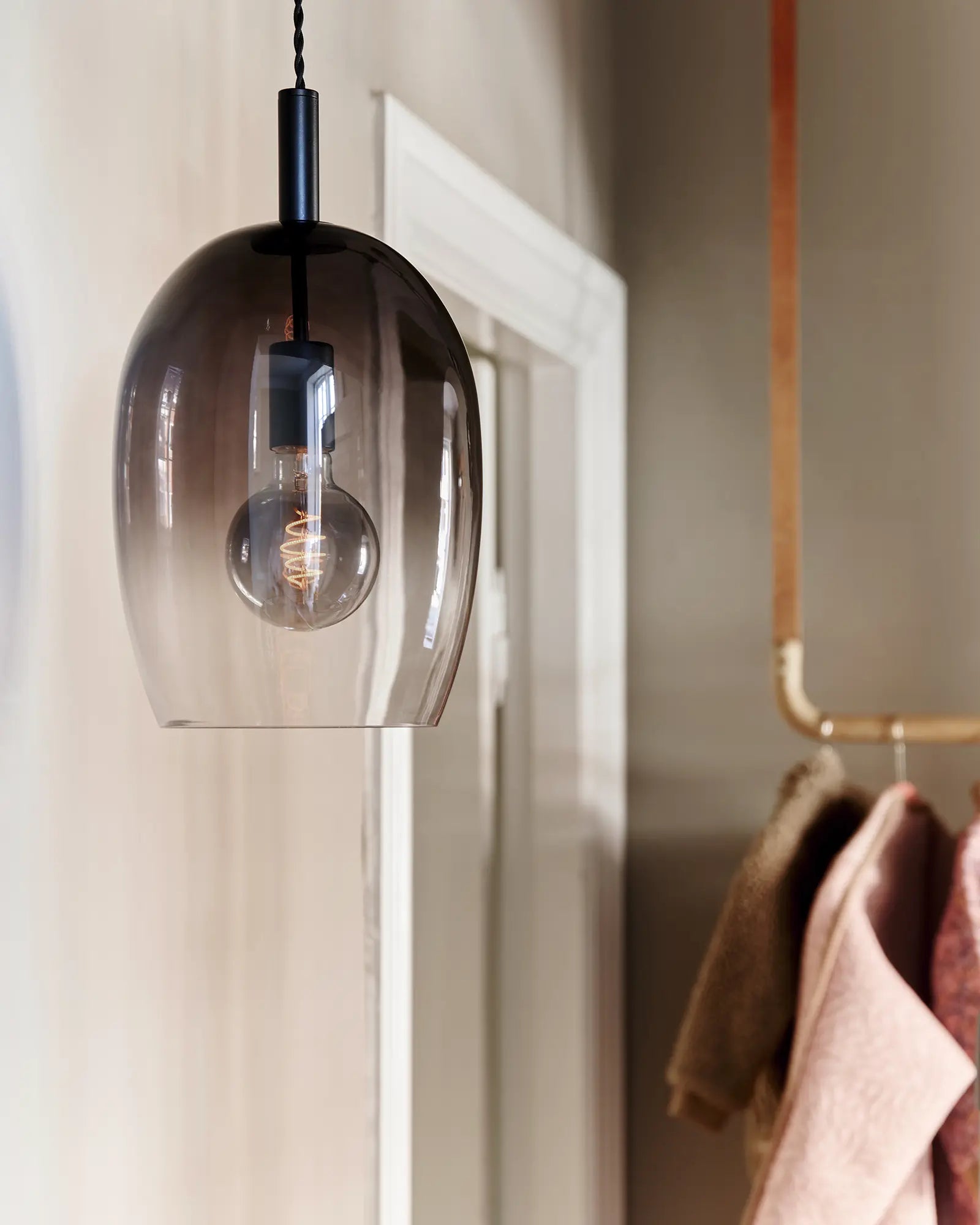 Uma blown glass pendant light detail in a shop