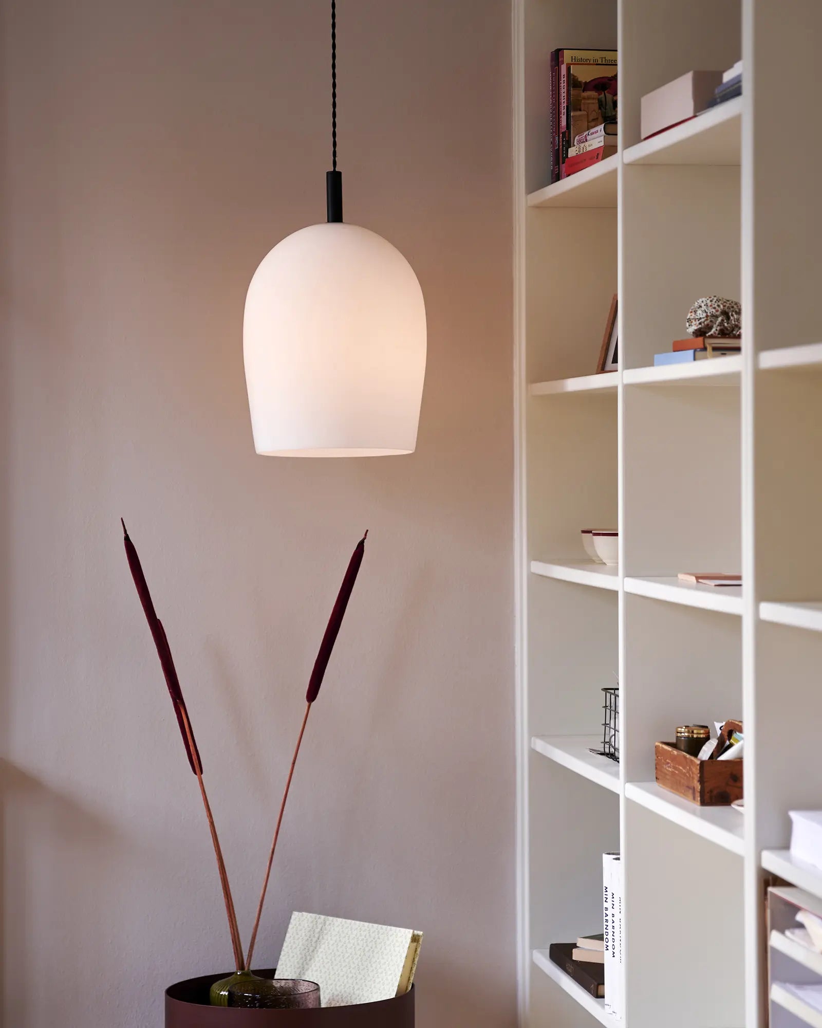 Uma blown glass pendant light above a coffee table