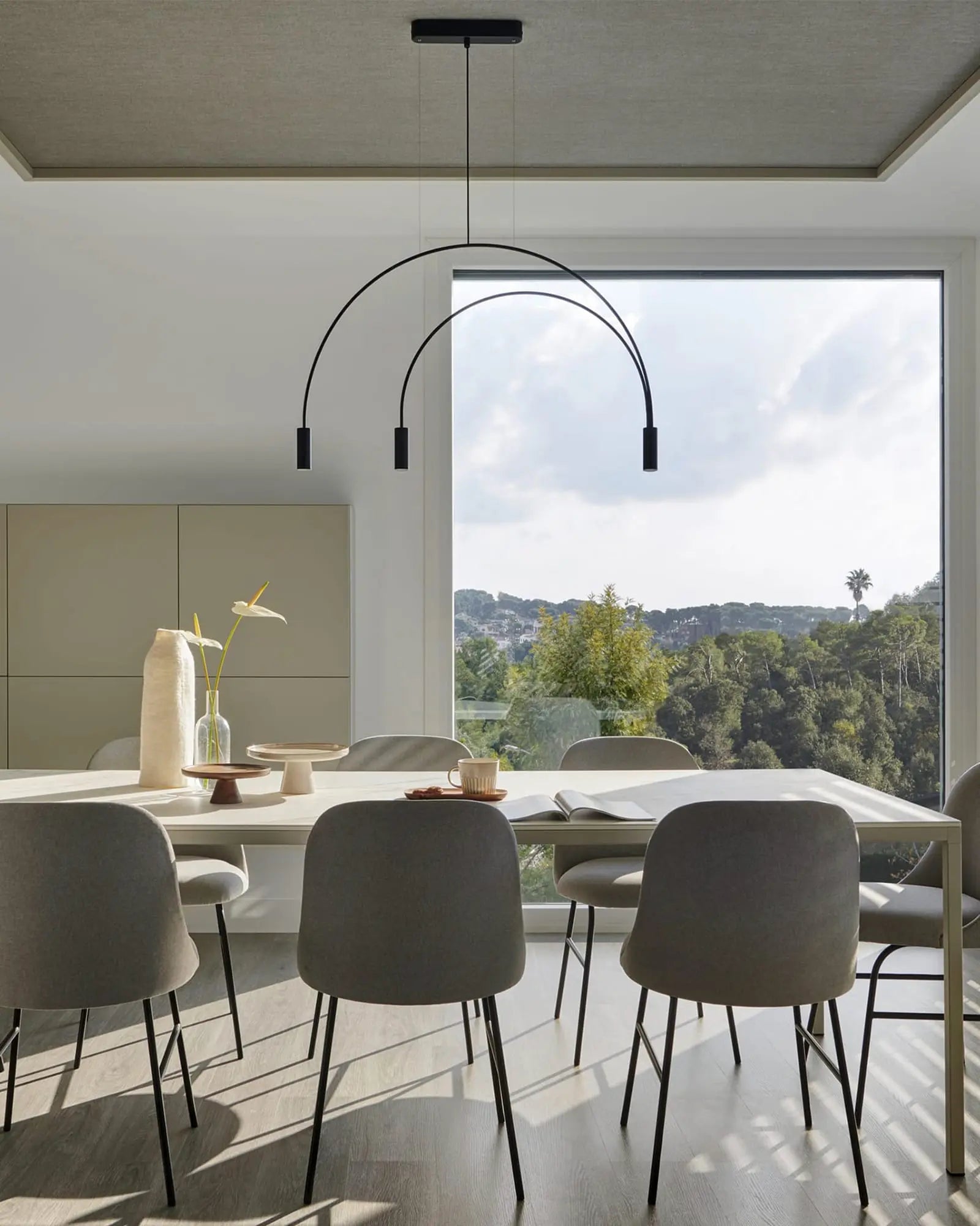 Volta Linear pendant light by Estiluz Lighting above dining table