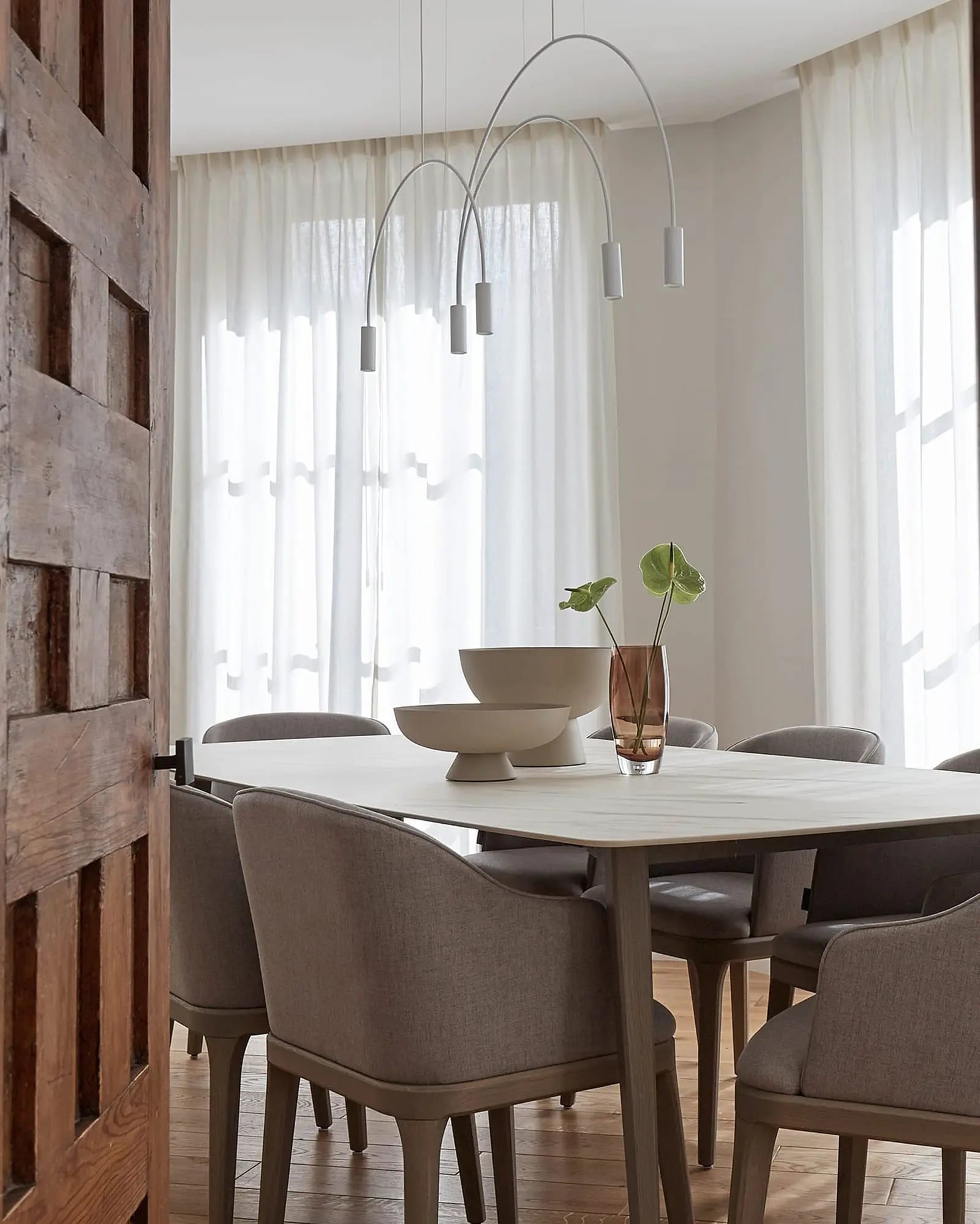Volta Linear pendant light by Estiluz Lighting above a dining table