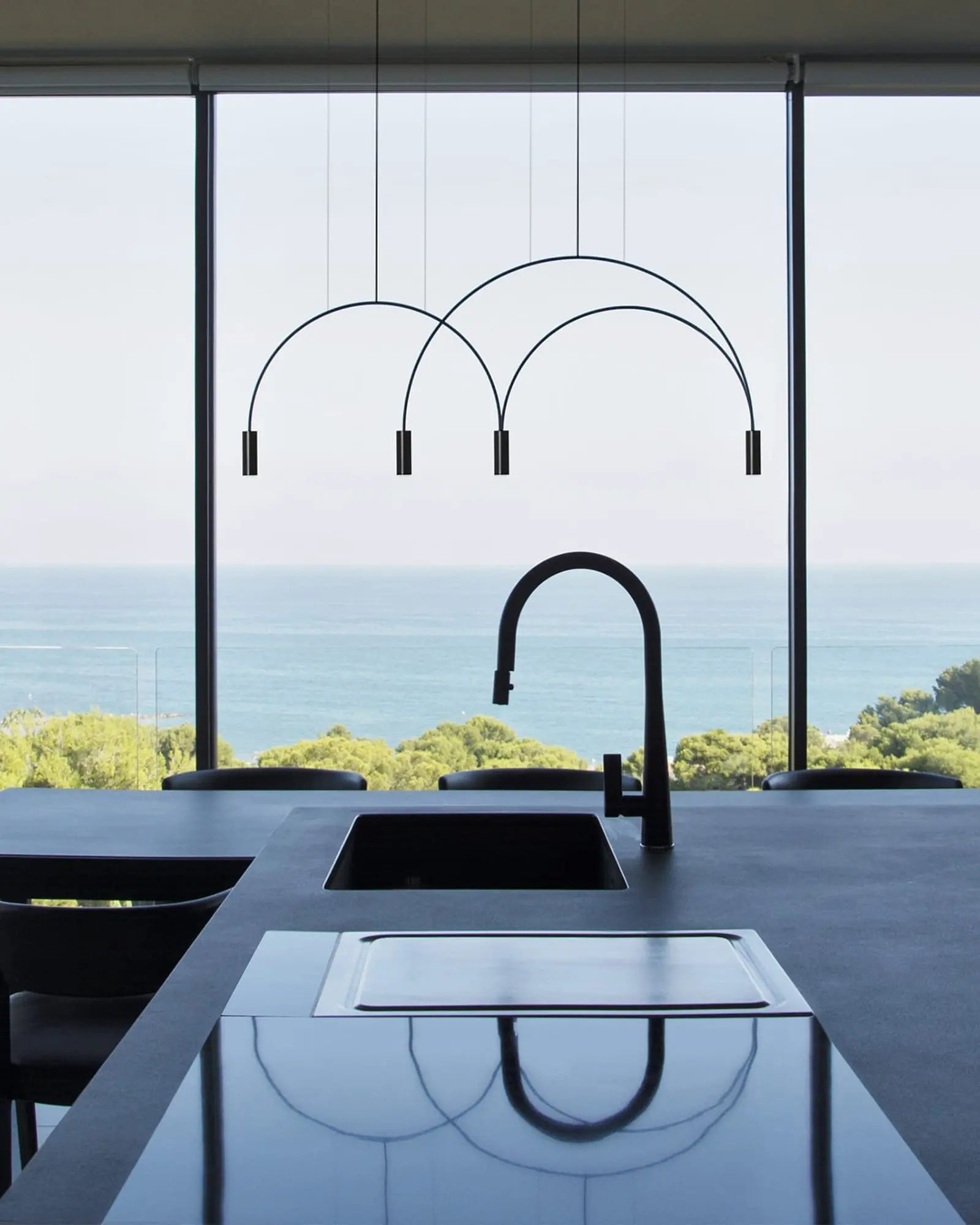 Volta Linear pendant light by Estiluz Lighting above a kitchen island