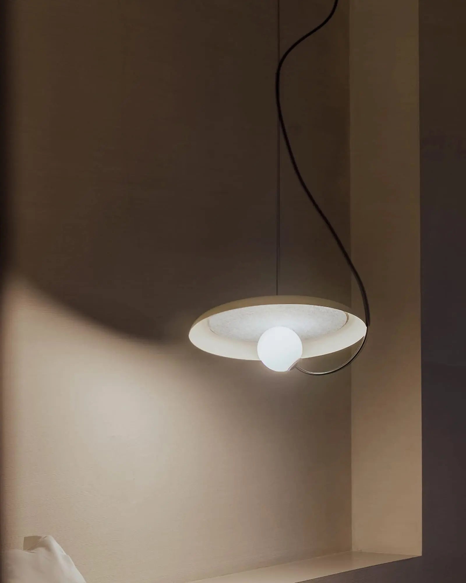 Wire pendant light in a bedroom bedside