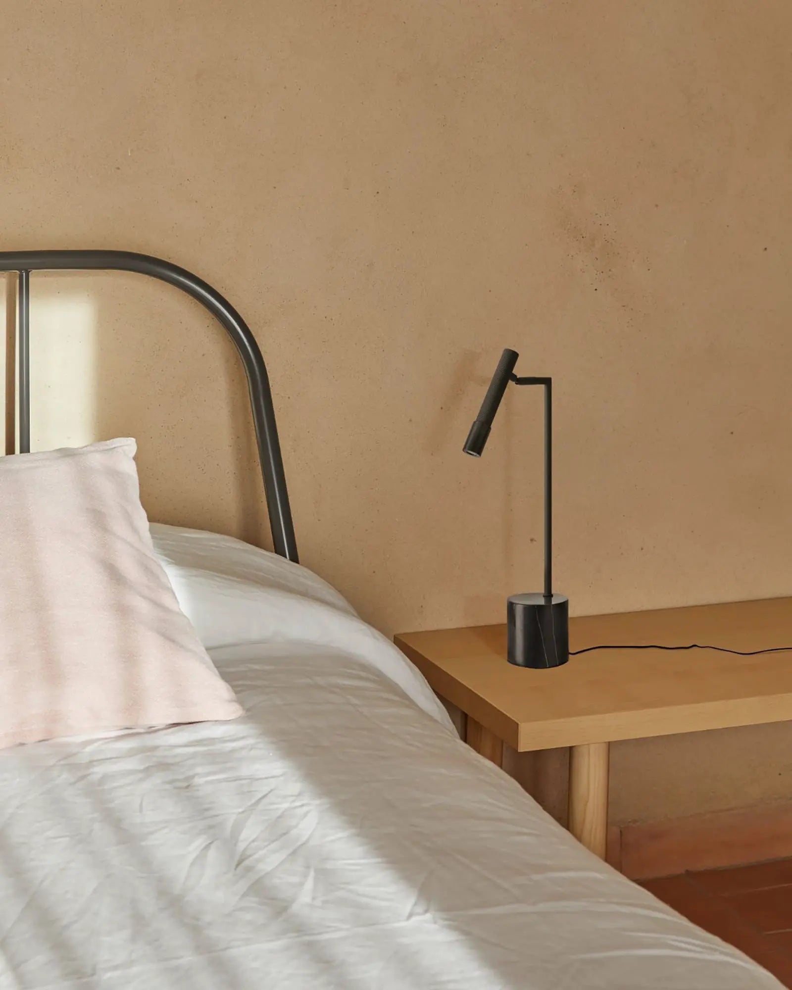 Ycro modern adjustable matte black table lamp on the bed side table