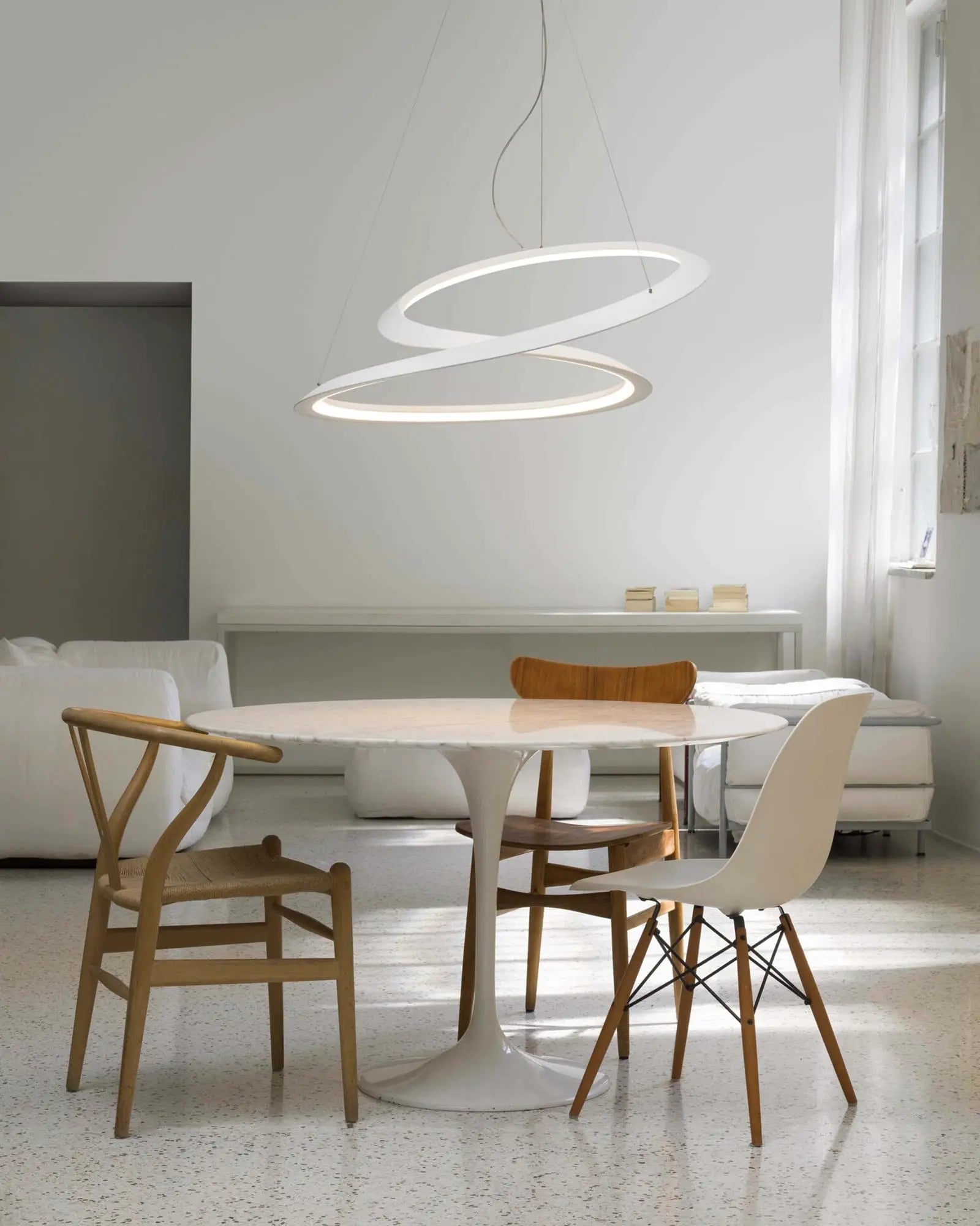 Kepler contemporary LED pendant light above a round table