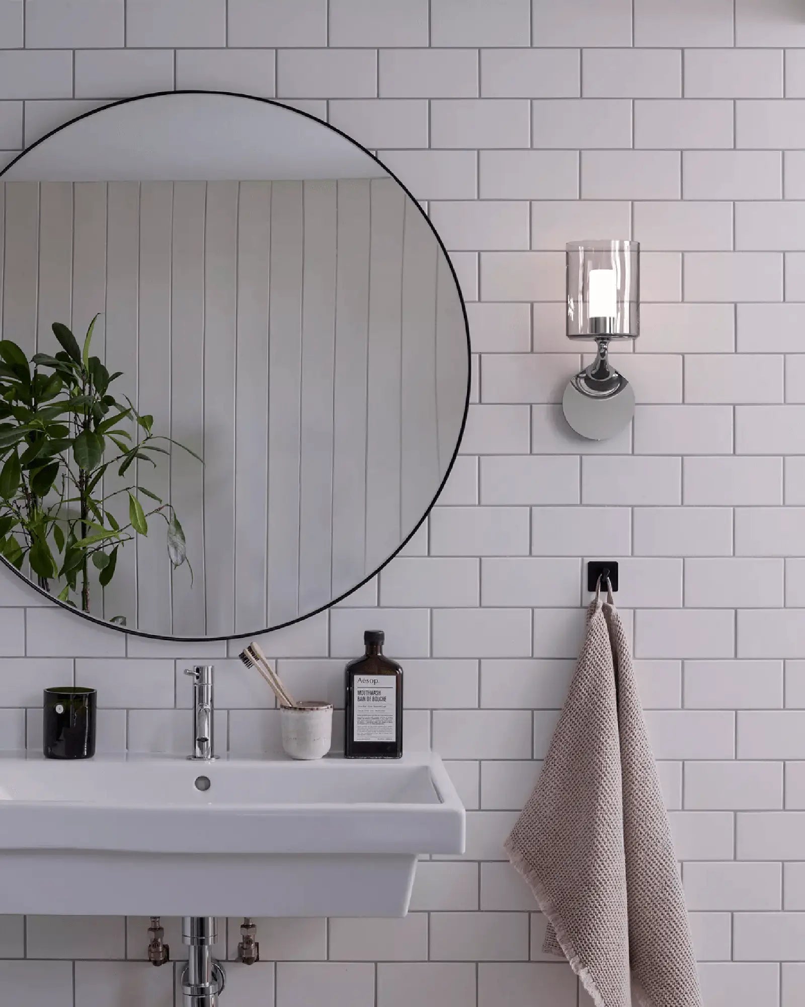 Elena contemporary wall light in metal and glass in bathroom on the mirror side