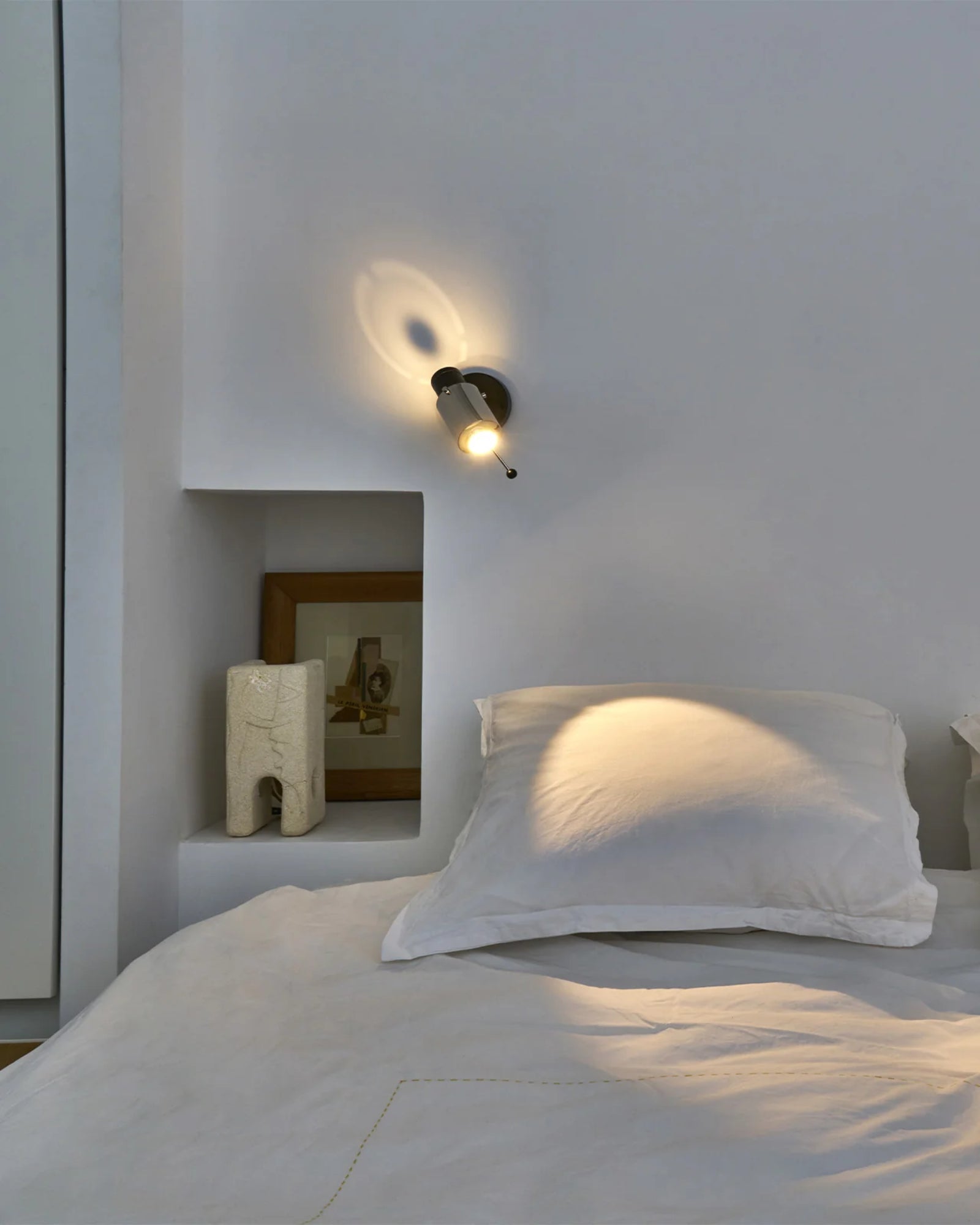 Biny Spot Wall Light by DCW Interiors featured in a modern contemporary bedroom | Nook Collections