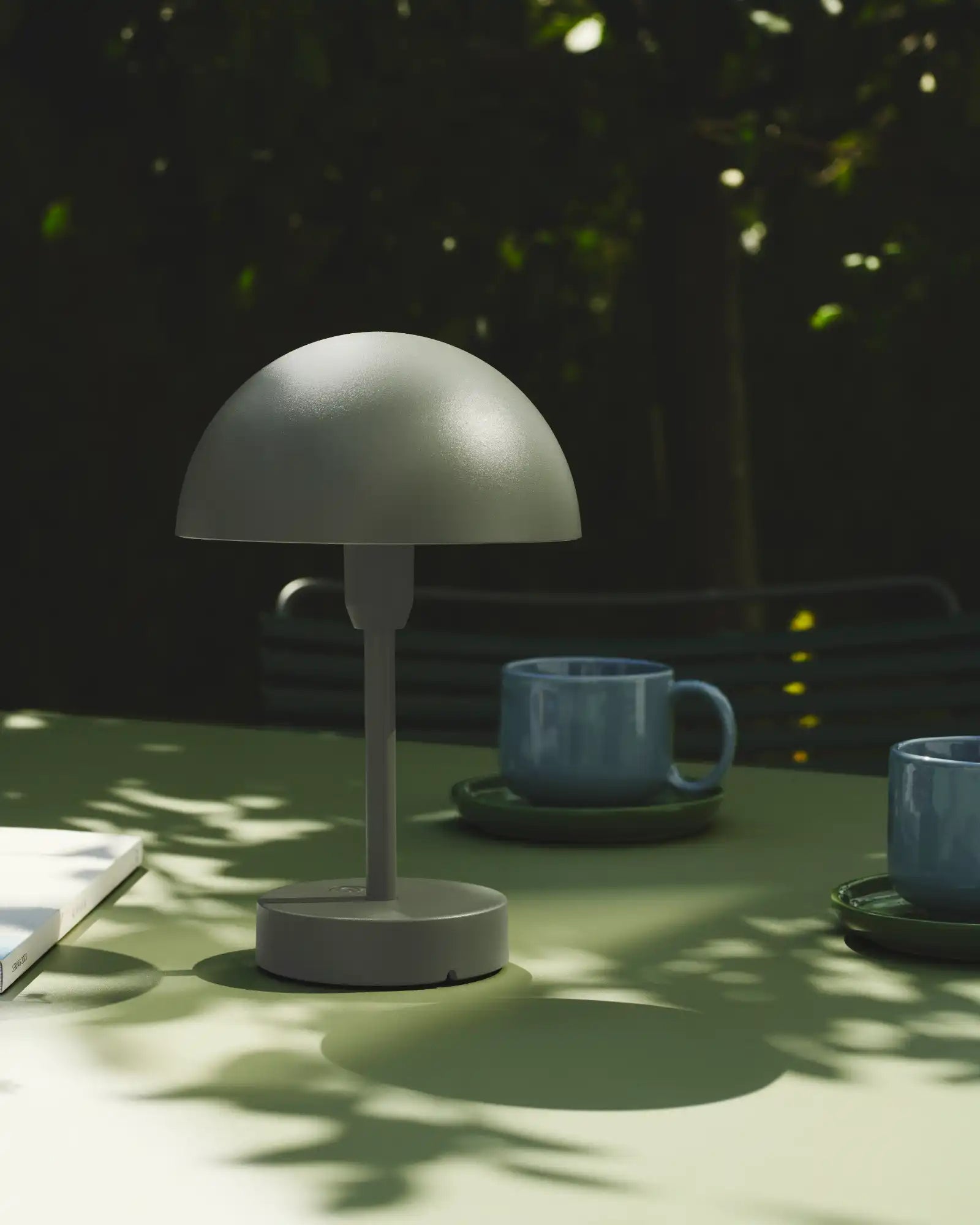 Ellen To-Go Table Lamp Olive Green by Nordlux Lighting featured in an outdoor lounge area | Nook Collections