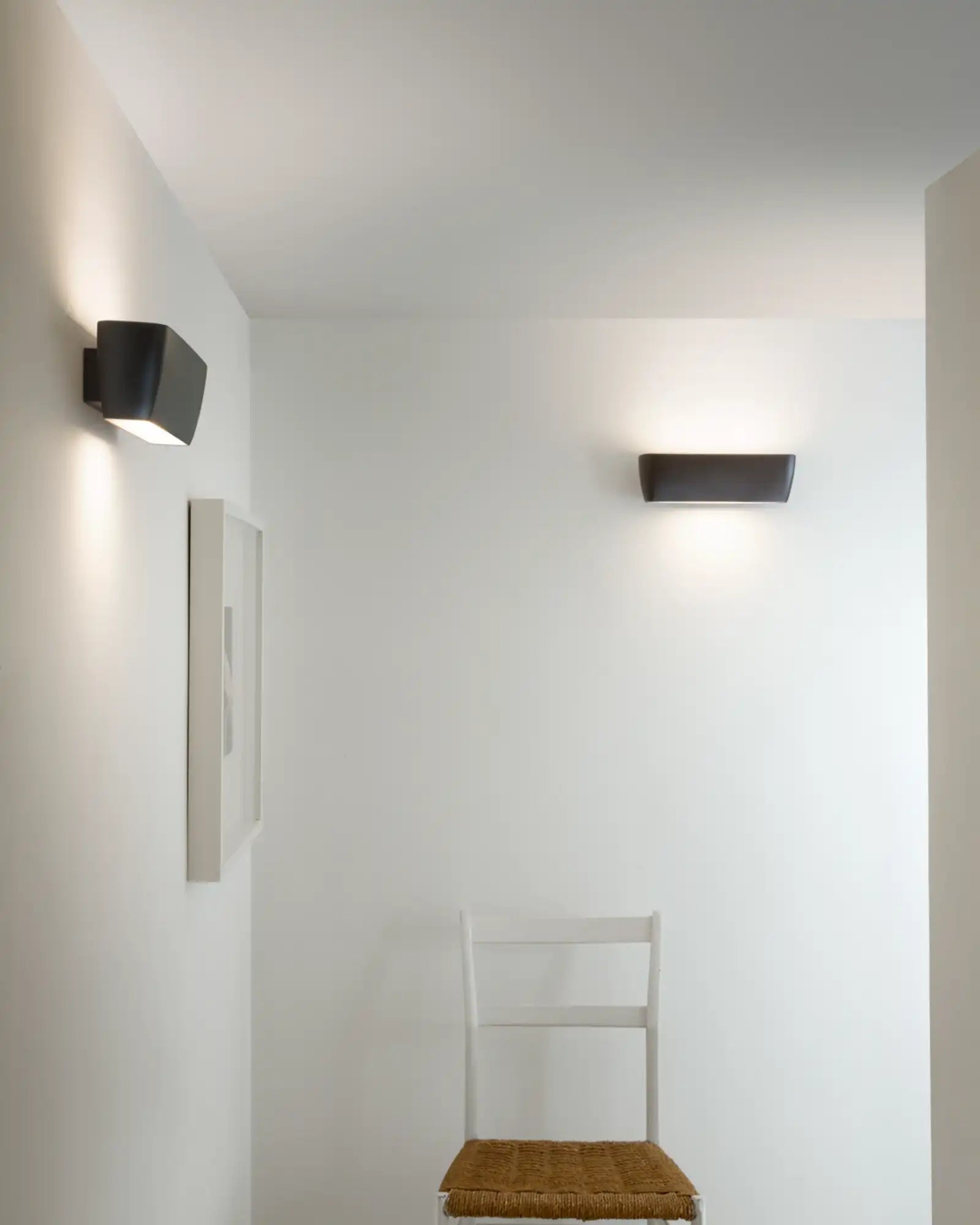 Flaca Wall Light by Nemo Lighting featured within a minimalist hallway | Nook Collections