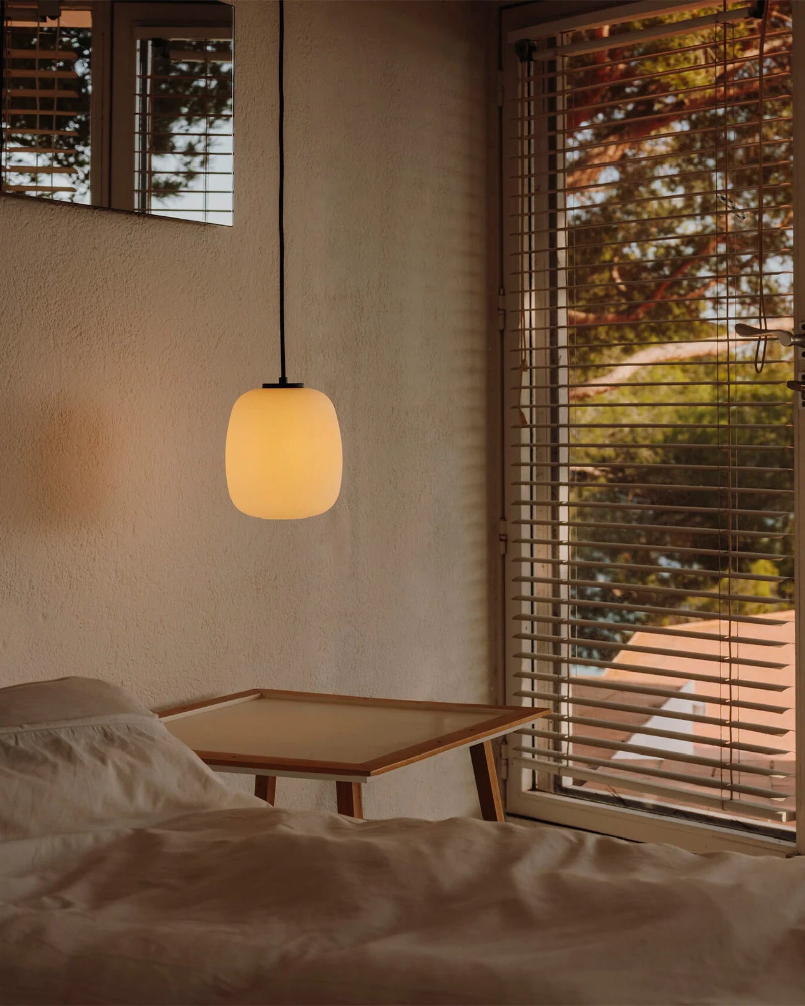 Globo Cesta Pendant Light by Santa & Cole featured in a modern contemporary bedroom | Nook Collections