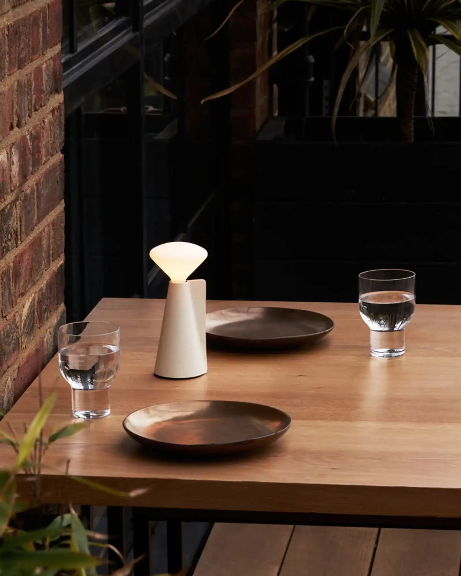 Mantle Portable Table Lamp by Tala featured within a contemporary restaurant | Nook Collections