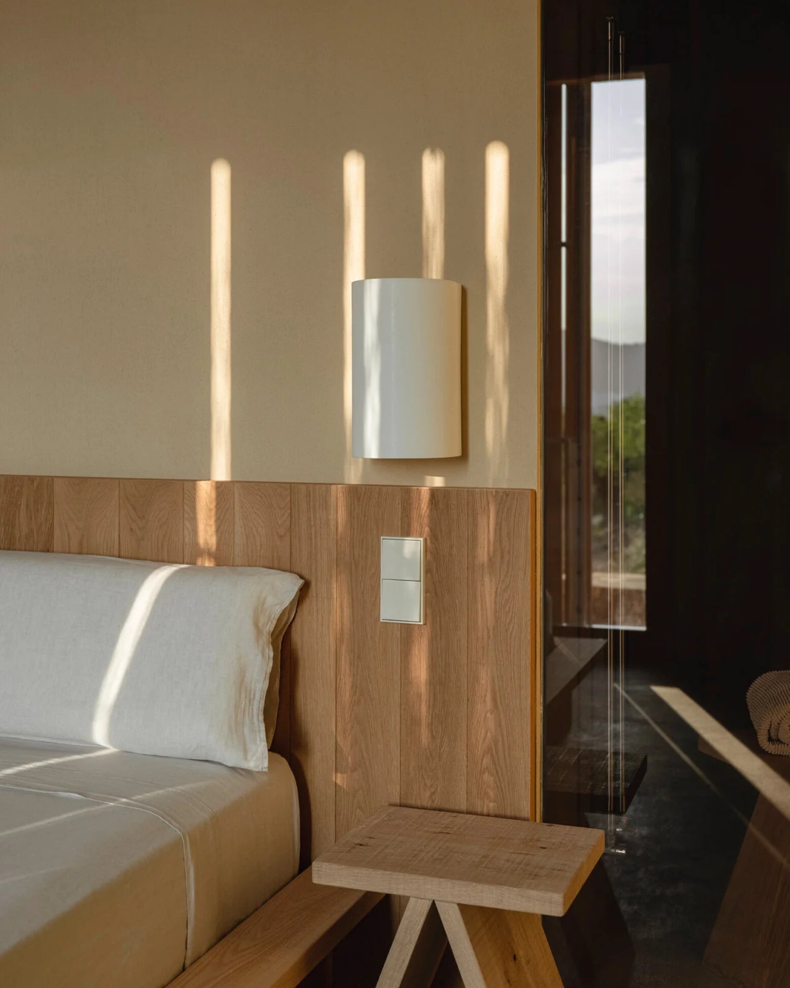 Singular Wall Light by Santa & Cole featured in a modern contemporary bedroom | Nook Collections