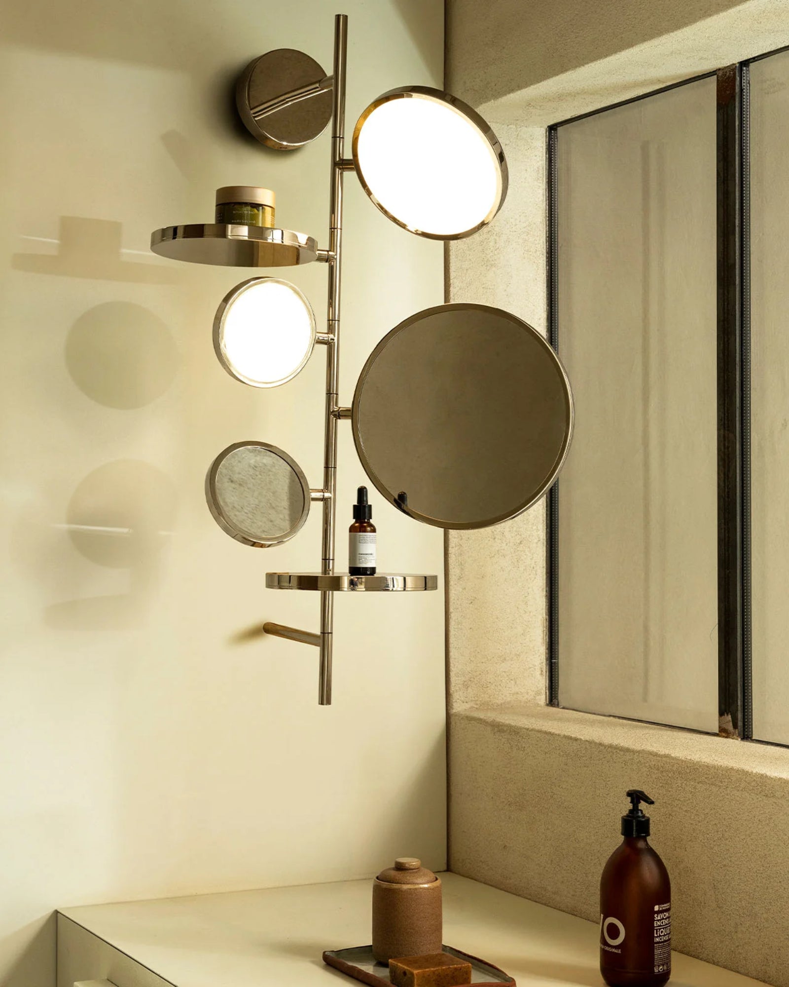 Tell Me Stories Wall Light by DCW Interiors featured in a modern contemporary bathroom | Nook Collections