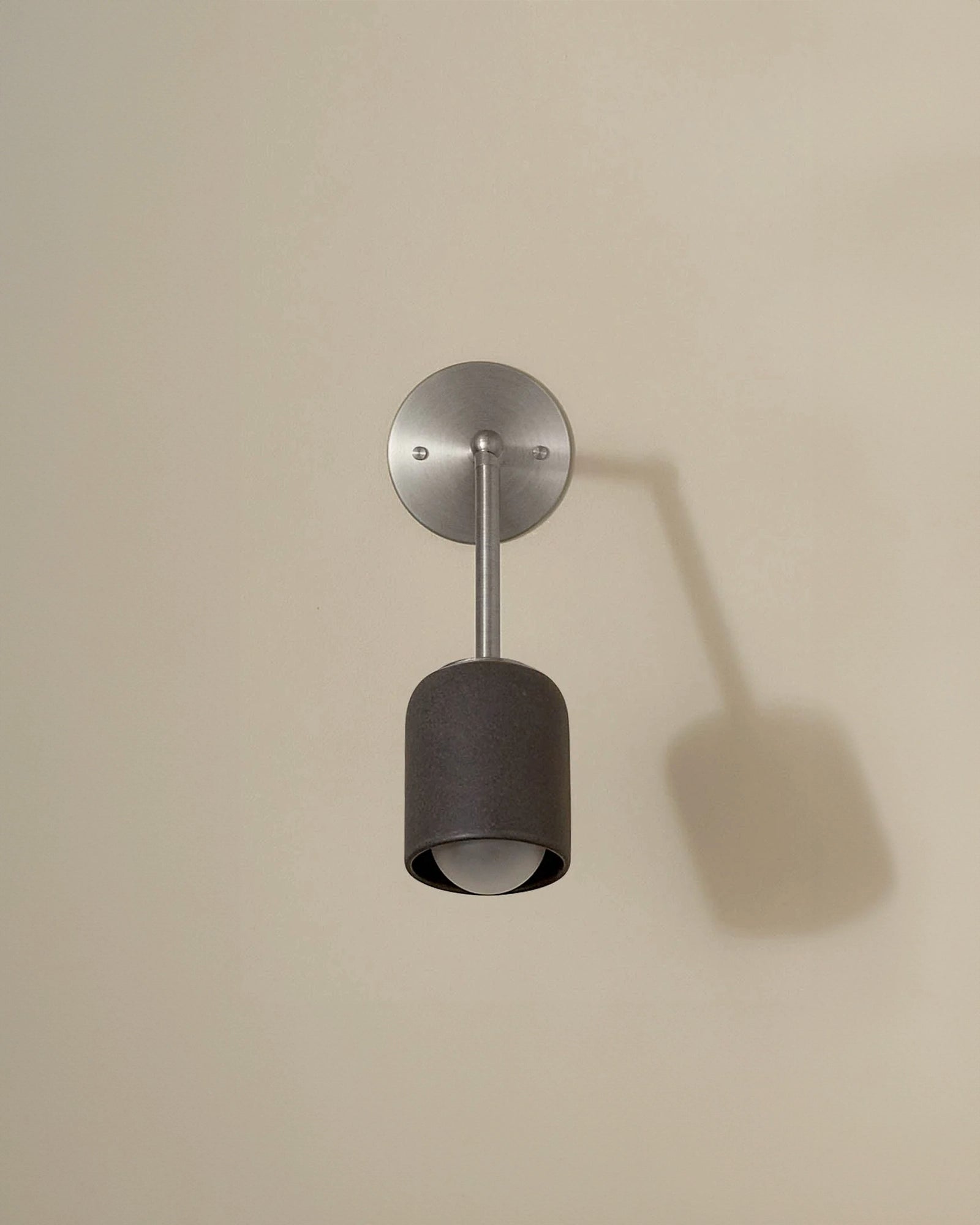 Terra 1 Long Arm Wall Light in lead finish with brushed nickel. -Nook Collections