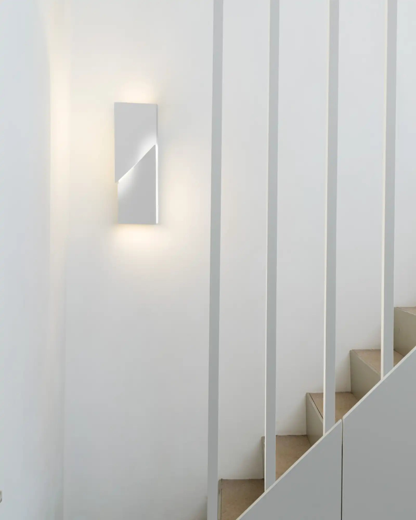 Wall Shadows Petit by Nemo Lighting featured in an all white stairway | Nook Collections