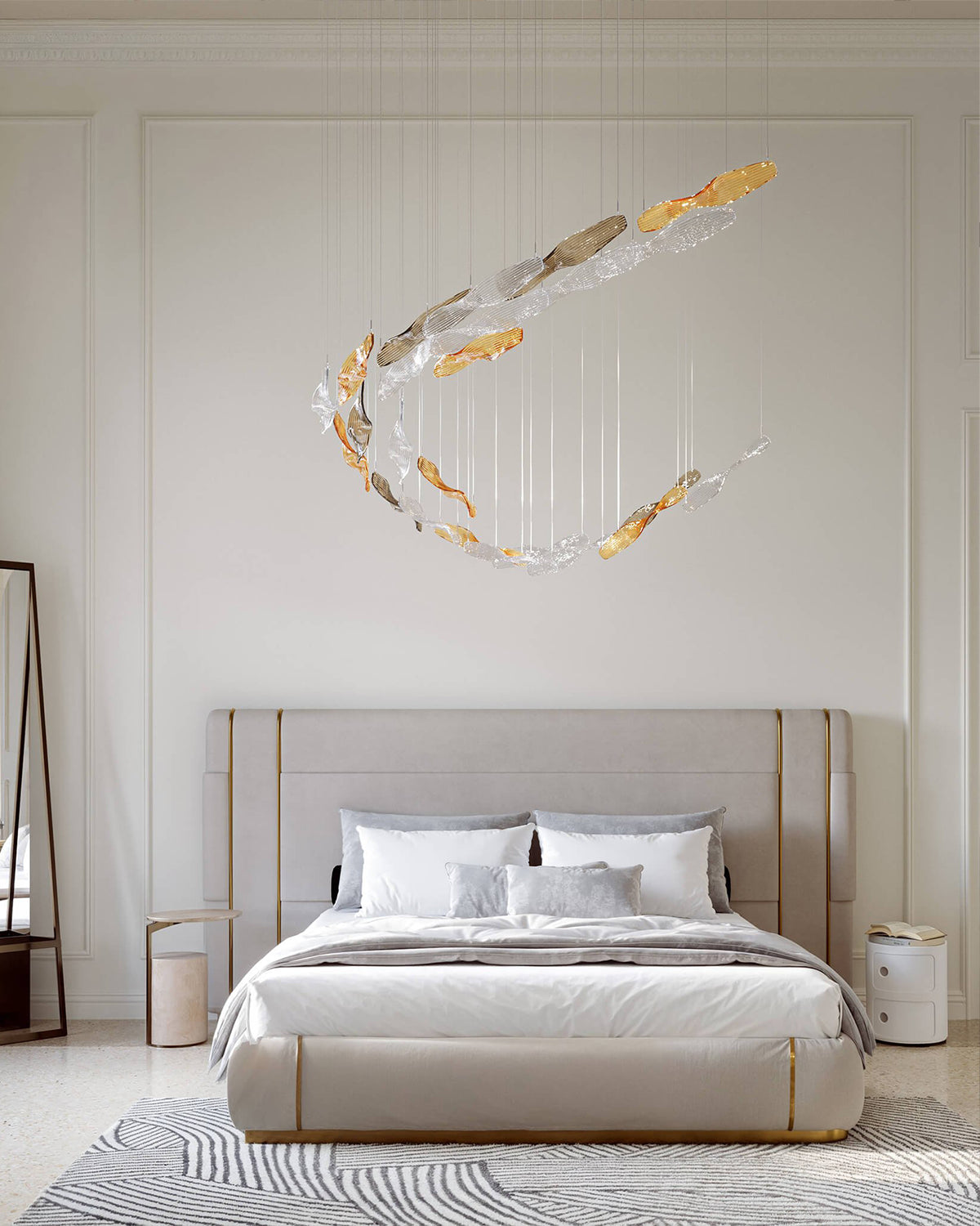 A modern bedroom featuring a large, abstract crescent-shaped chandelier with gold and clear glass elements suspended above a bed with neutral beige bedding and a light wood headboard.