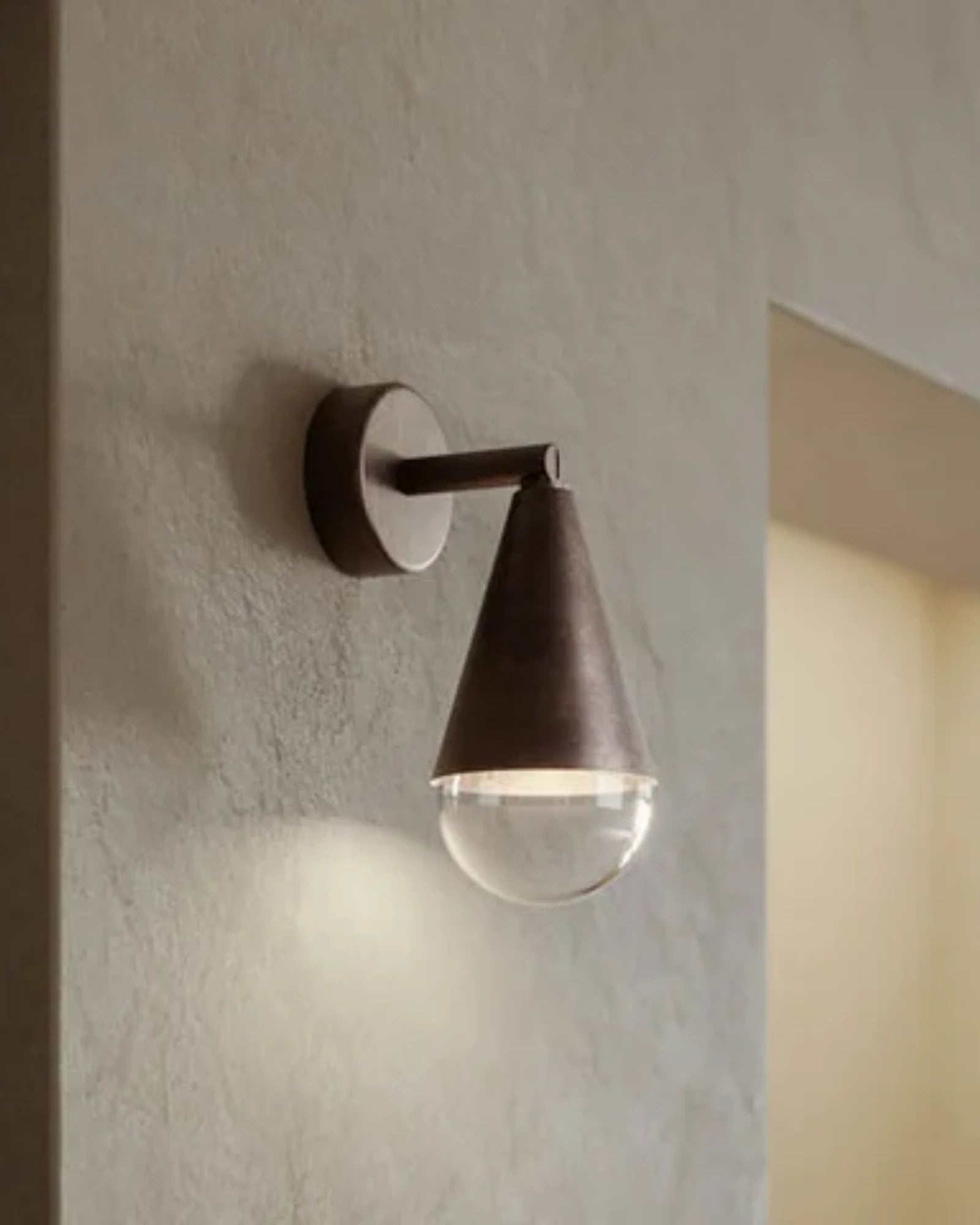 Modern wall-mounted light fixture on a textured wall