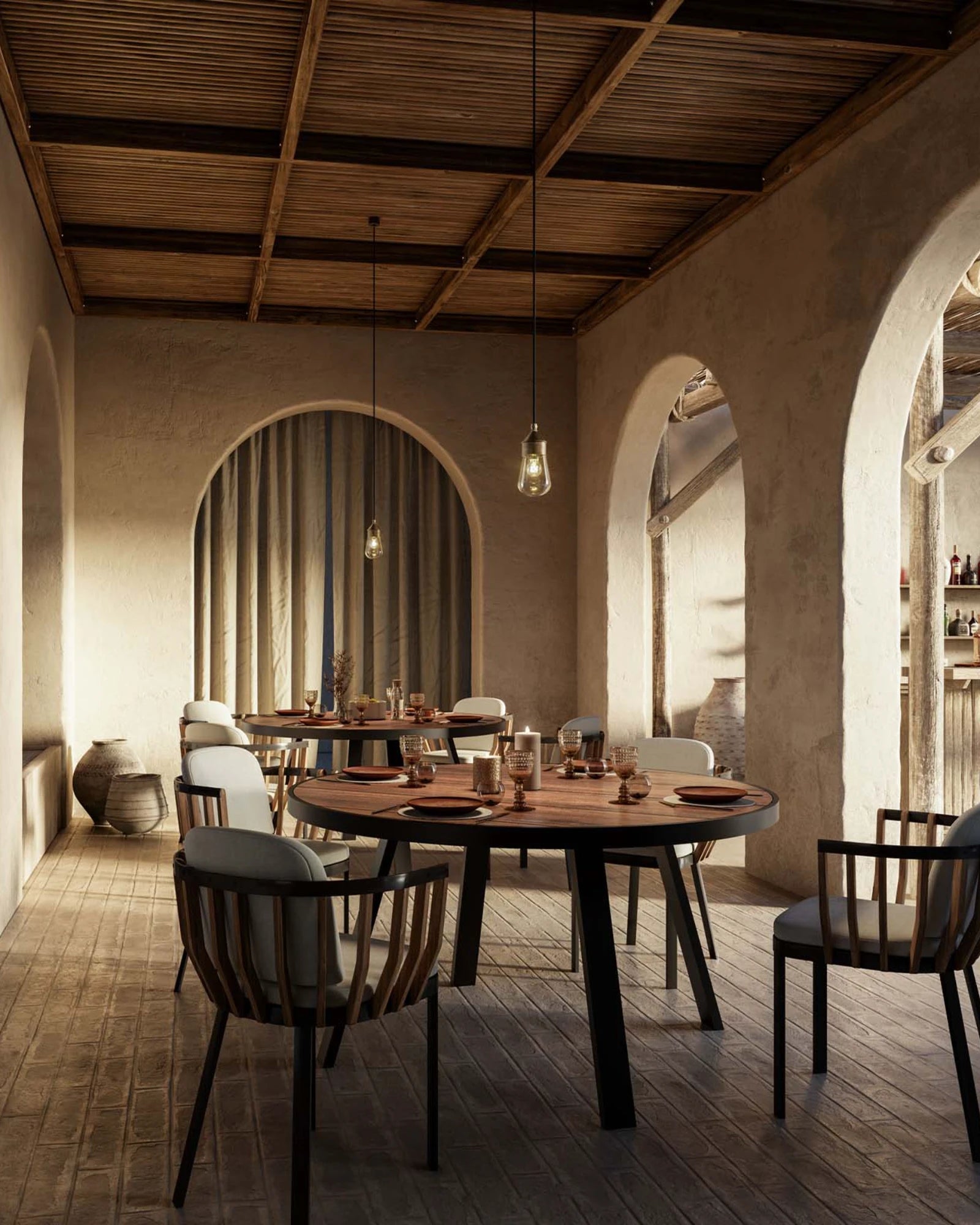 Dining area with wooden tables and chairs in a rustic setting with Drop Mini Single Pendant Light by Il Fanale lighting the dining room up.