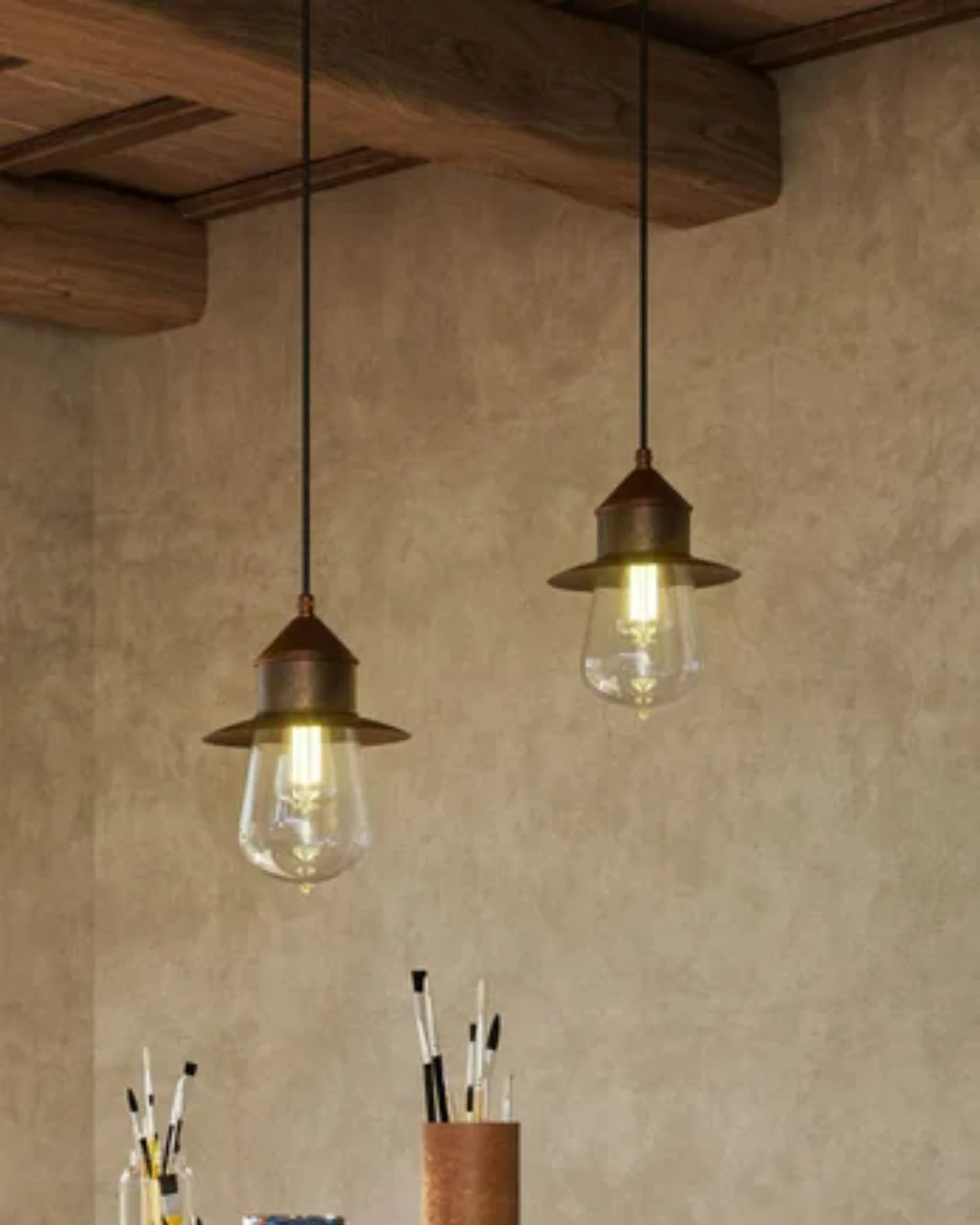 Two vintage-style pendant lights hanging from a wooden ceiling.
