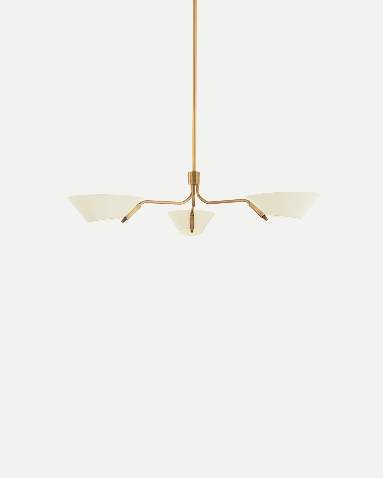Modern chandelier with gold finish and white glass shades on a light gray background