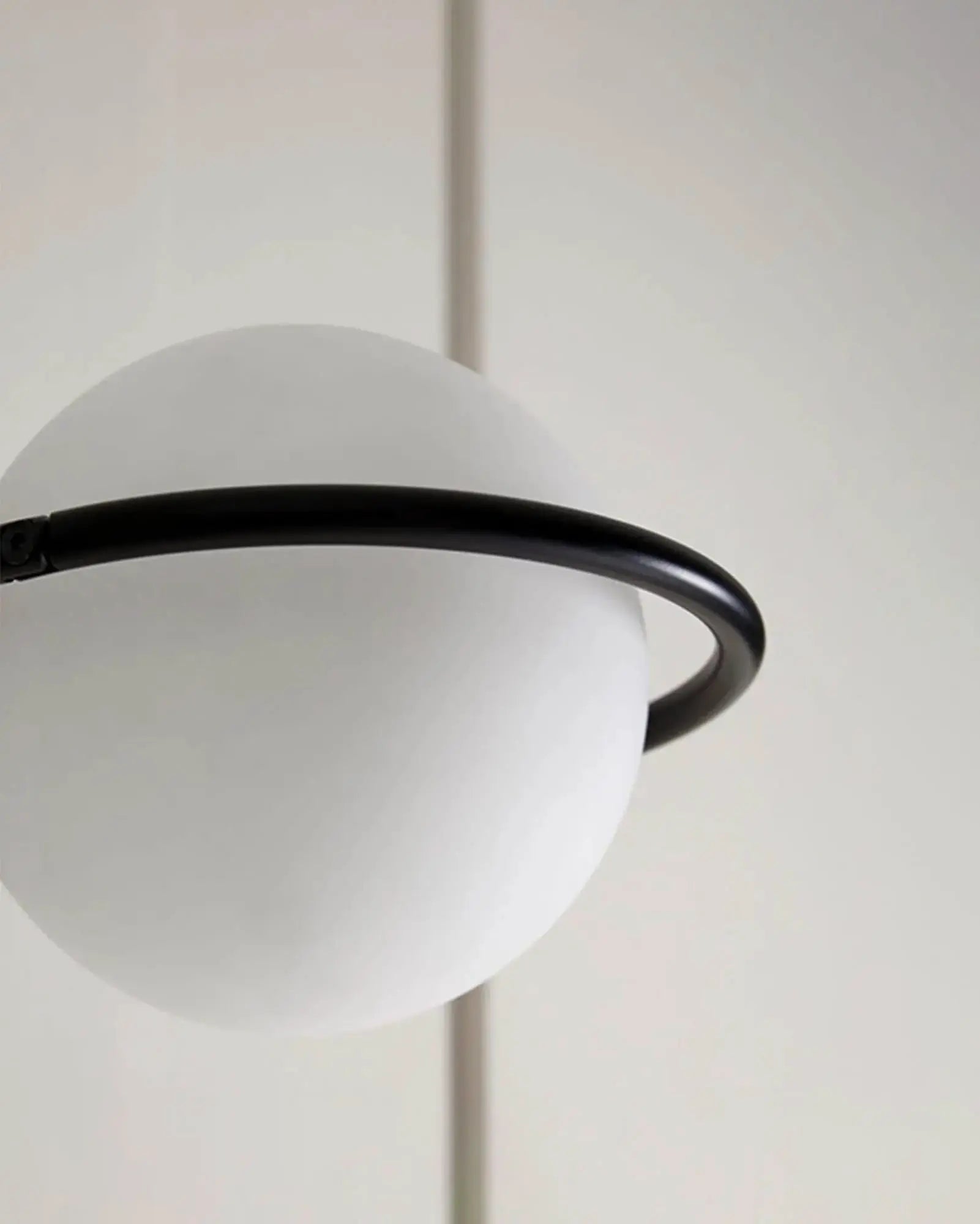 Abbacus wall light opal orb and metal ring in black detail