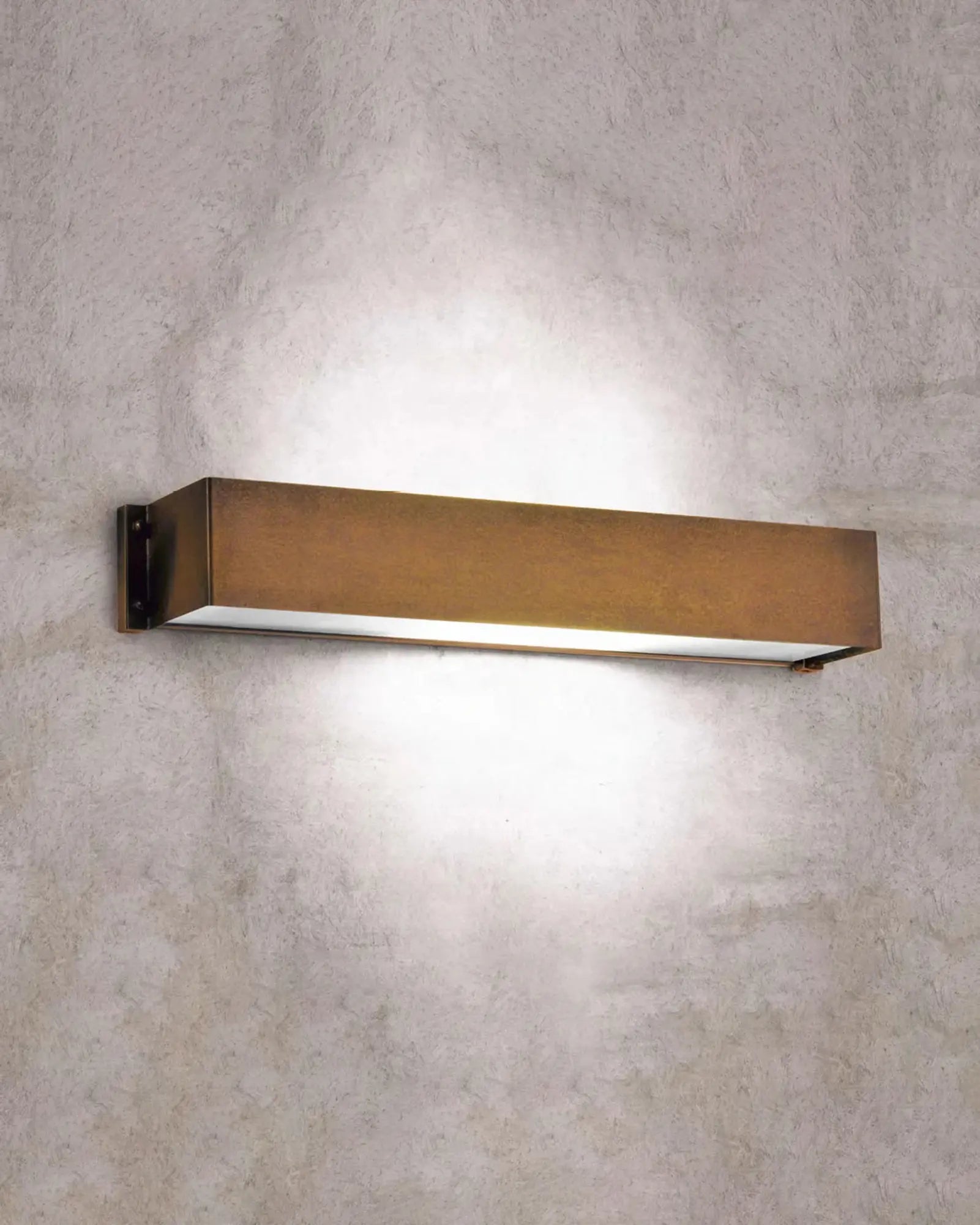 Allegro Rectangular Brass wall light made in Italy on concrete wall