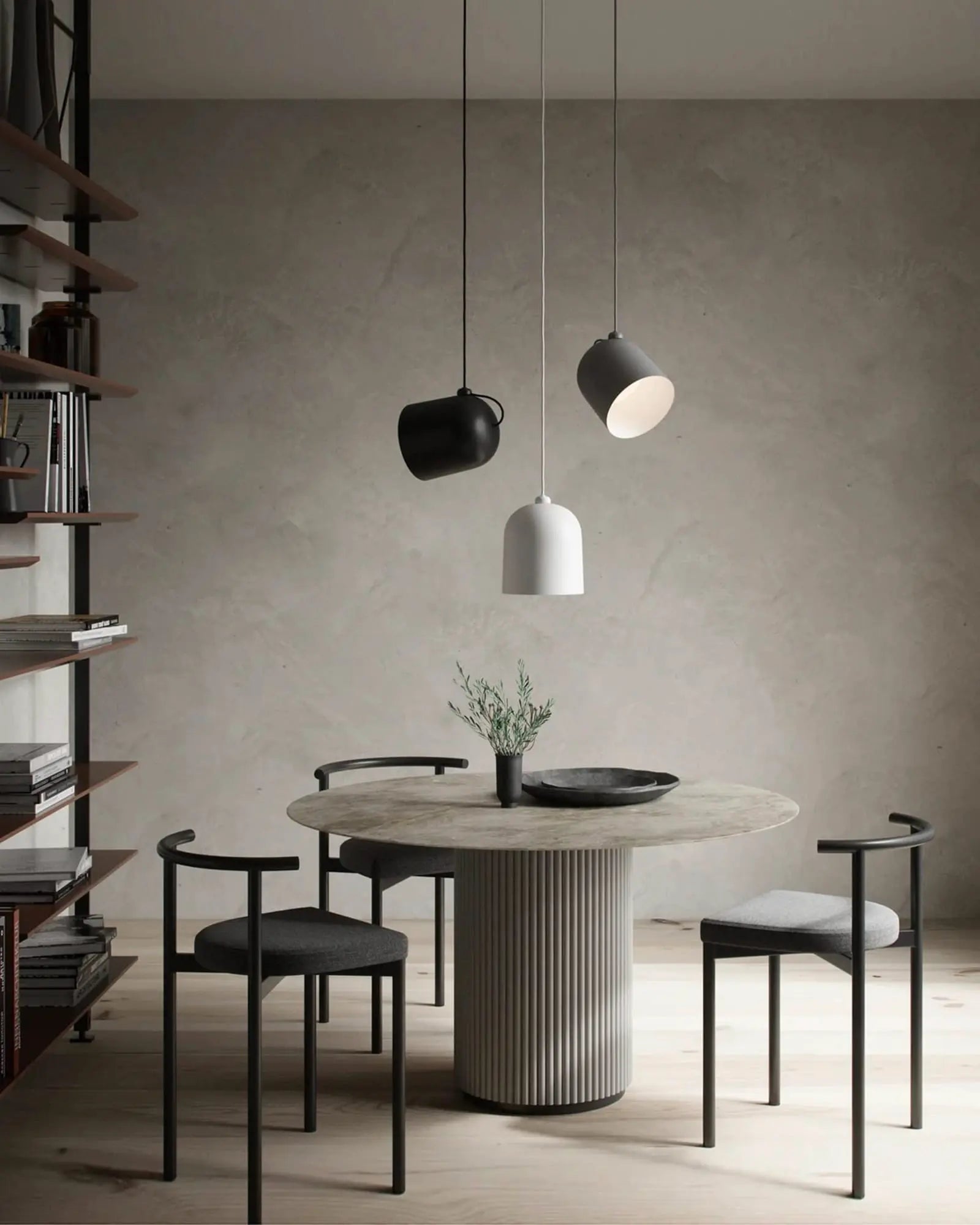 Angle scandinavian pendant light cluster above round dining table
