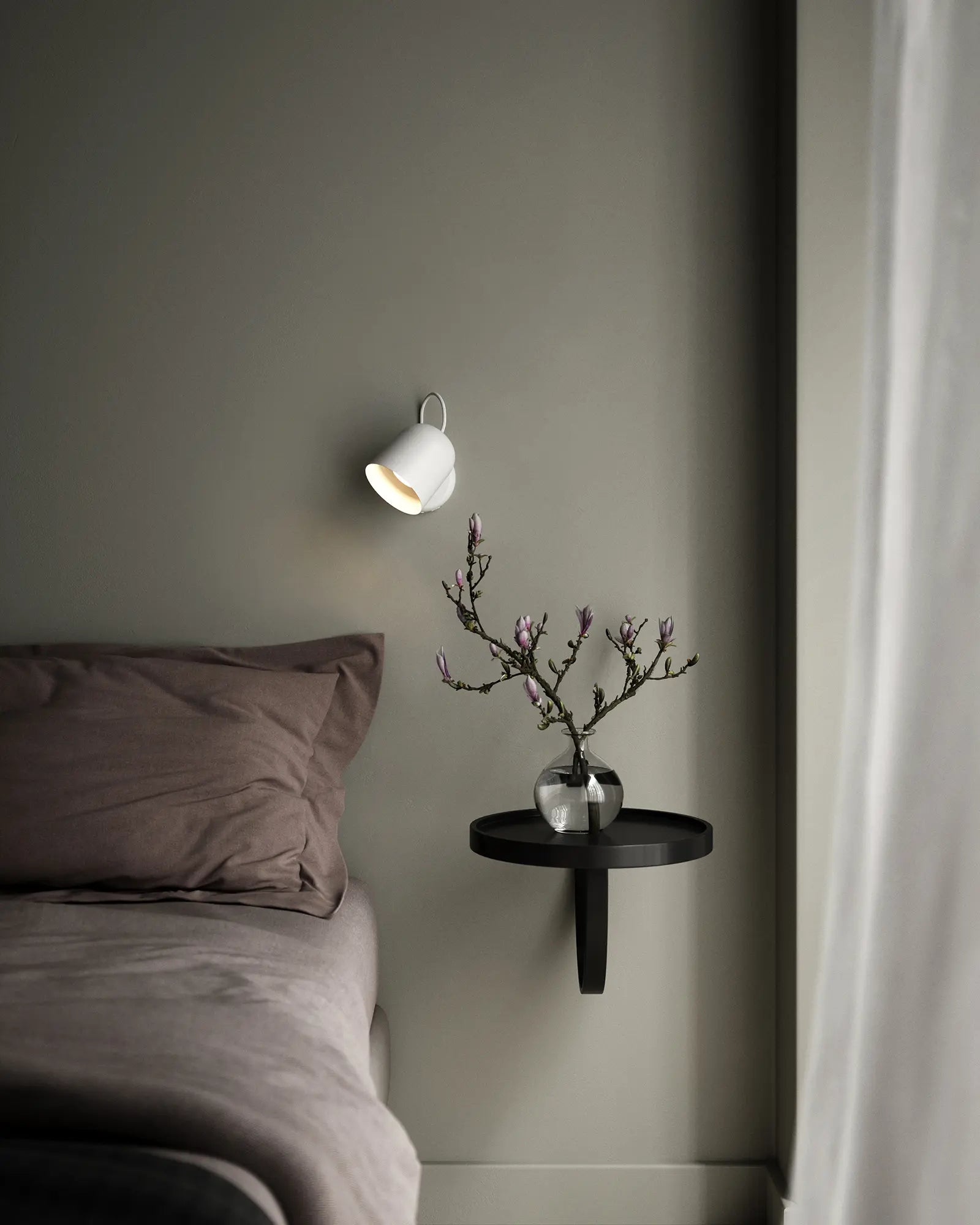Angle adjustable Scandinavian wall light on a bed side