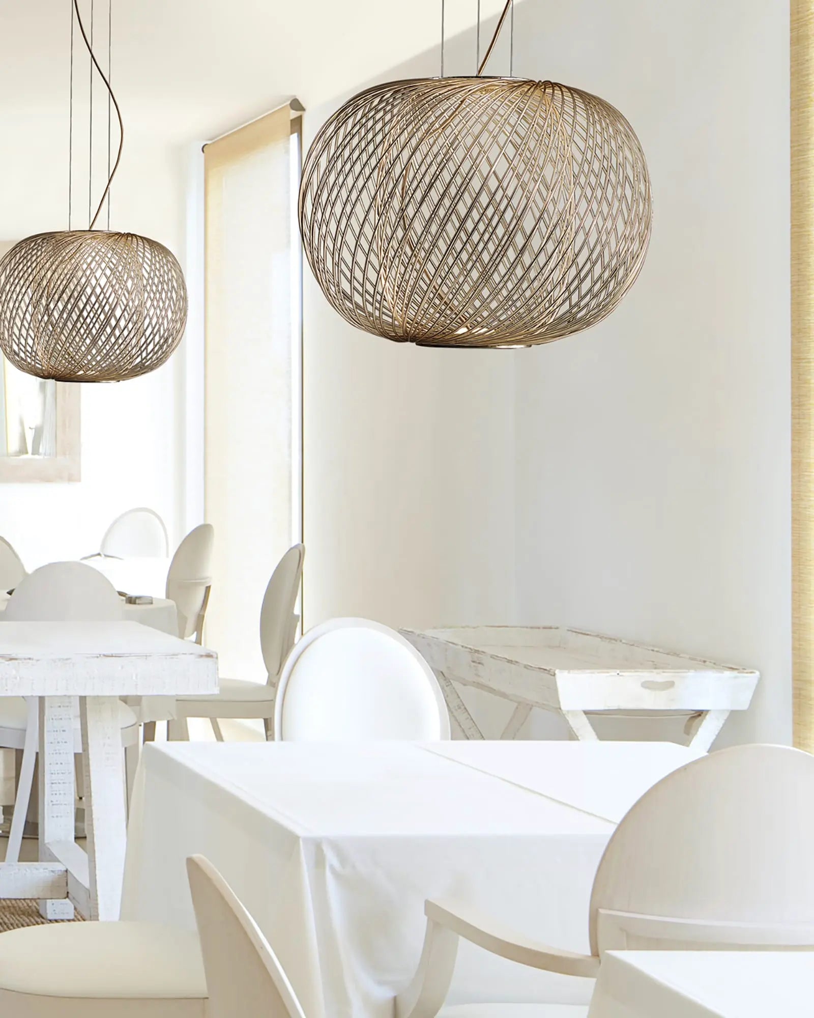 Anwar 45 contemporary hand welded pendant light cluster over dining tables in a restaurant